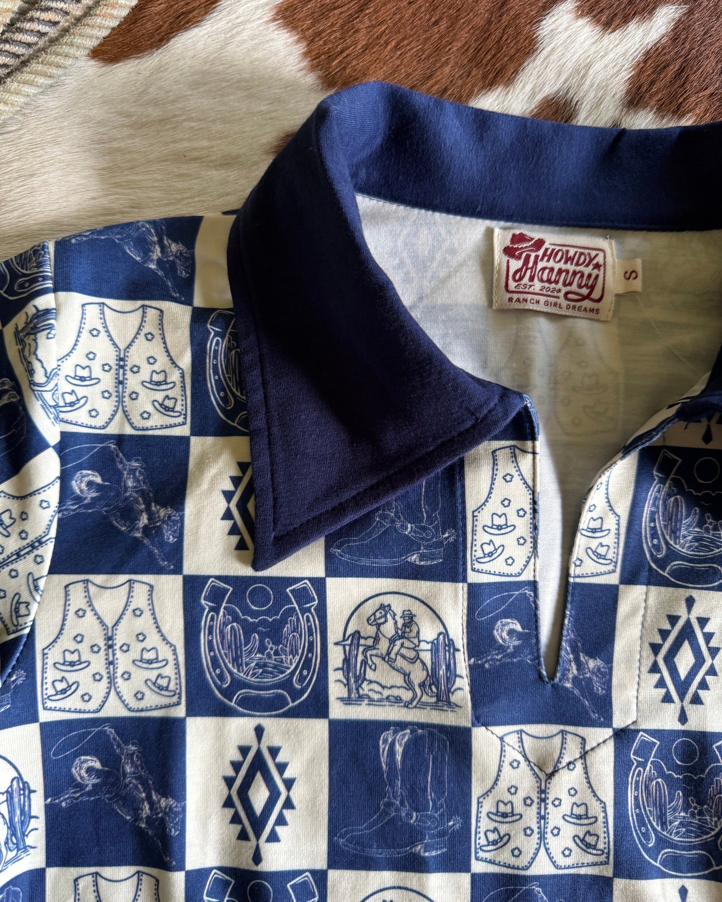 blue and white patterned with a brand tag on a brown and white shirt surface