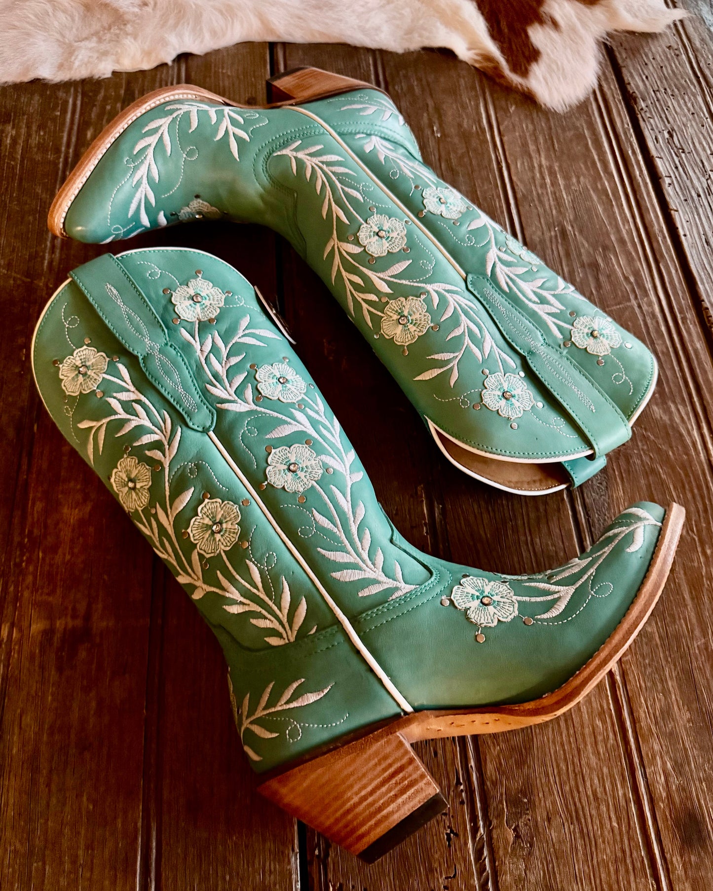 Ariat Romance Western Embroidered boots on rustic wood background