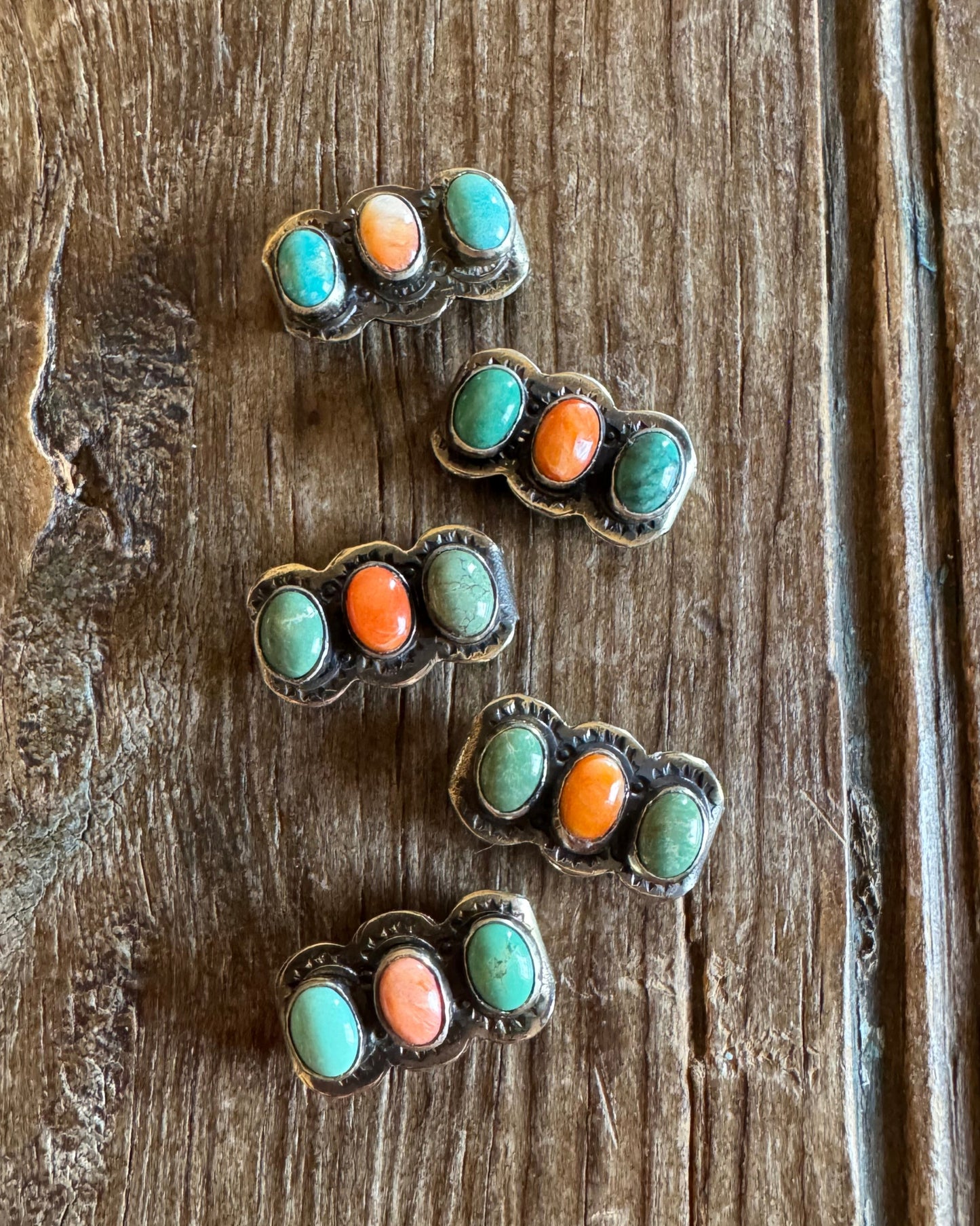 turquoise and orange spiny watch slides on rustic wood background
