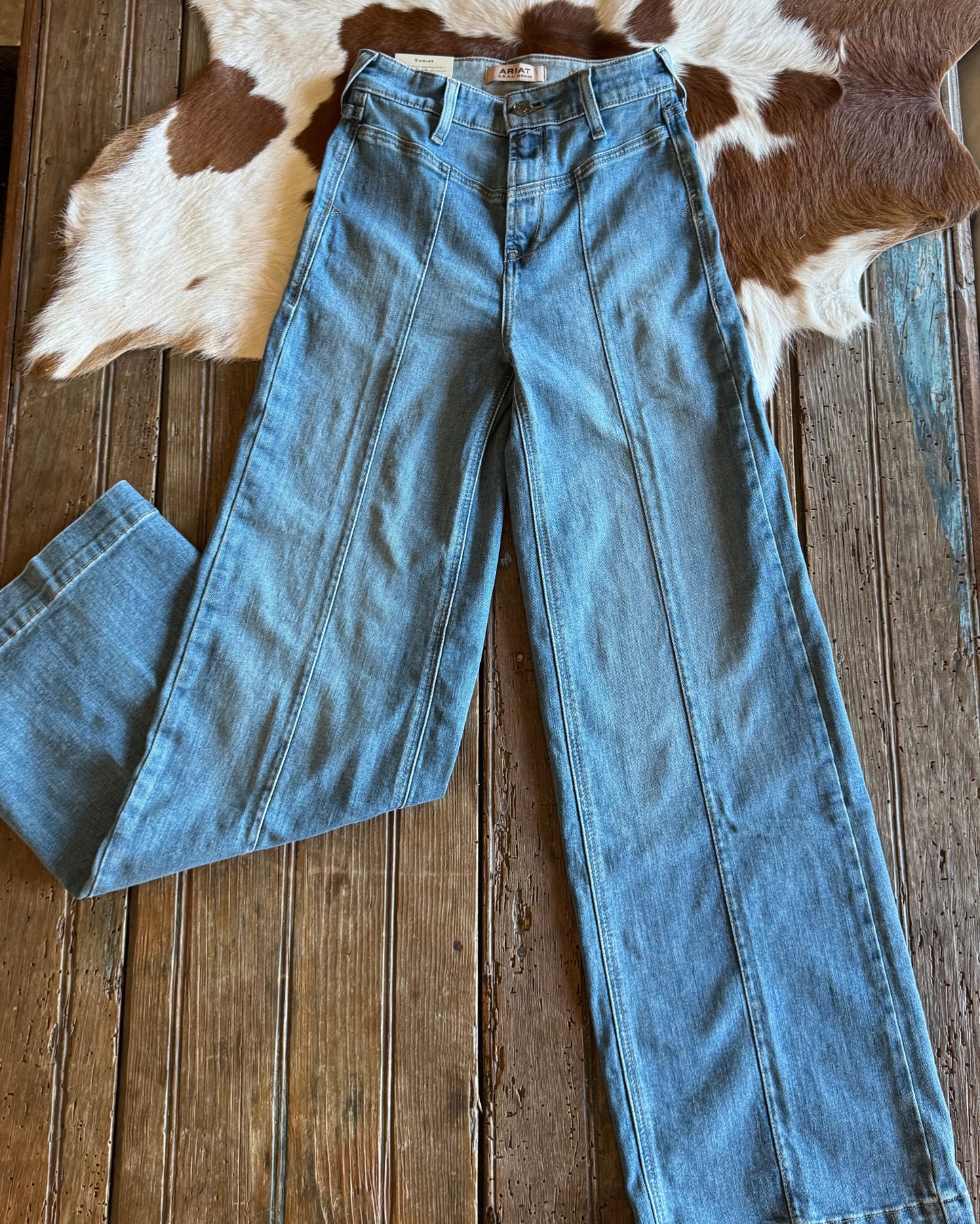 Front of wide leg jeans on rustic wood background