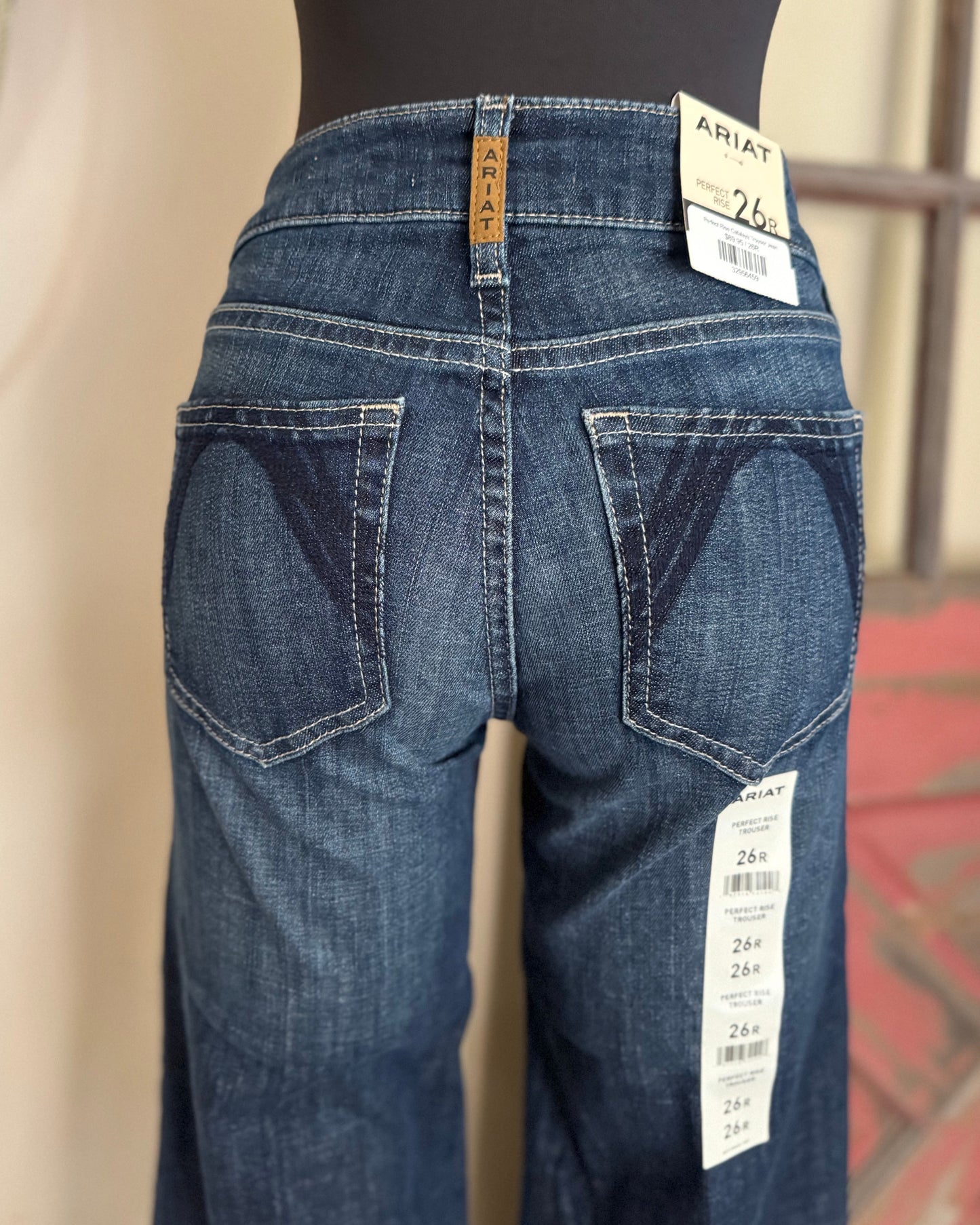 Blue jeans on a mannequin with Ariat label