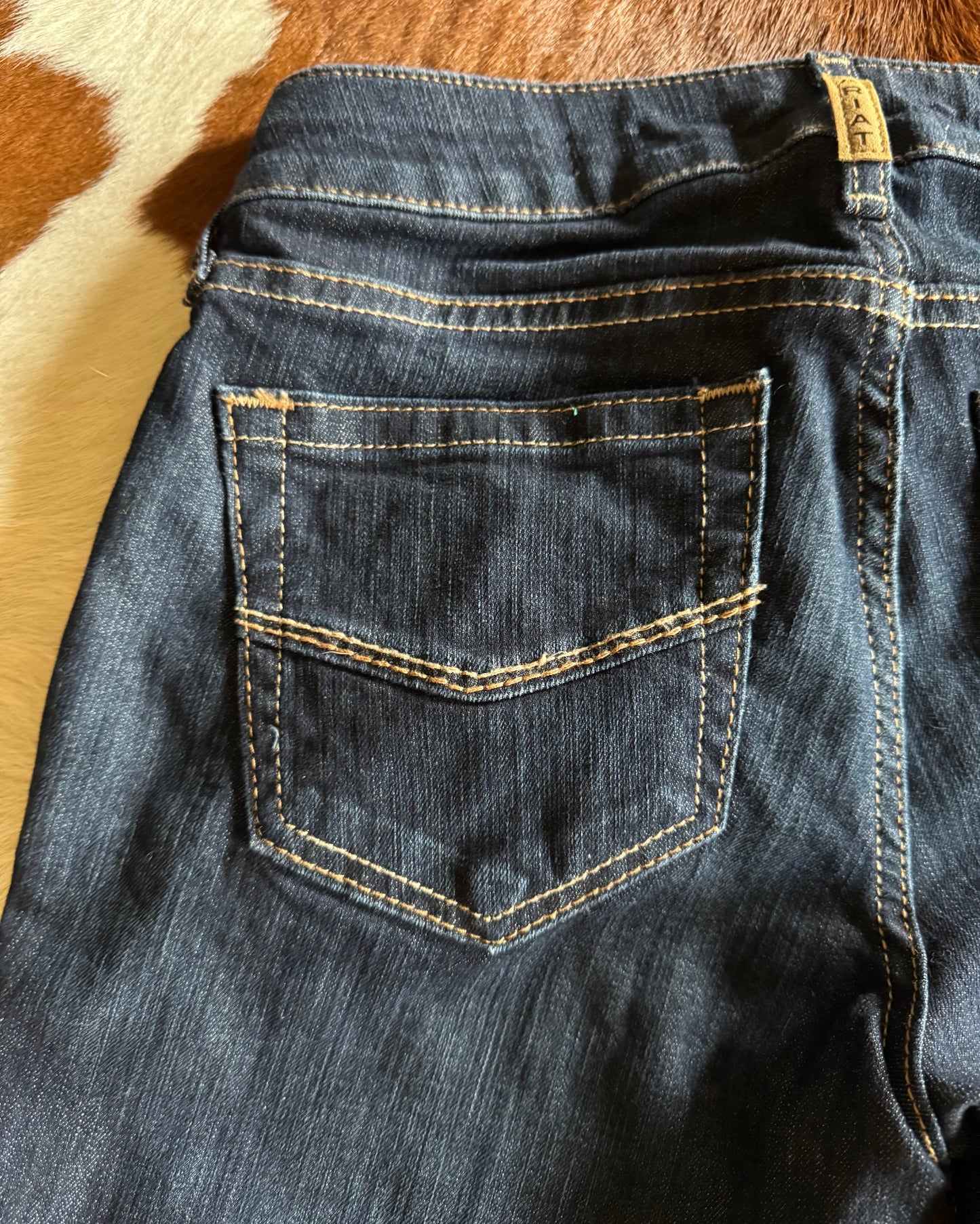 Close up of back pocket of Ophelia Perfect Rise Trouser Jeans on cowhide background