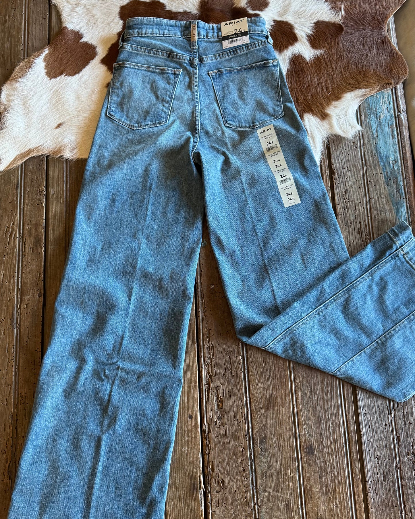 Back of wide leg jeans on rustic wood background