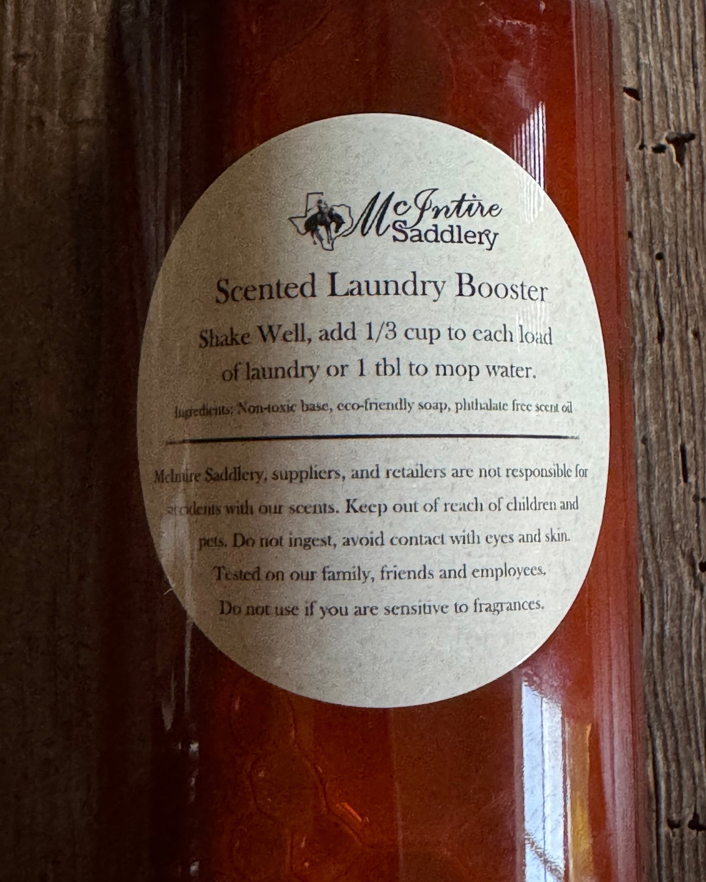 Bottle of laundry booster with a label on a wooden surface