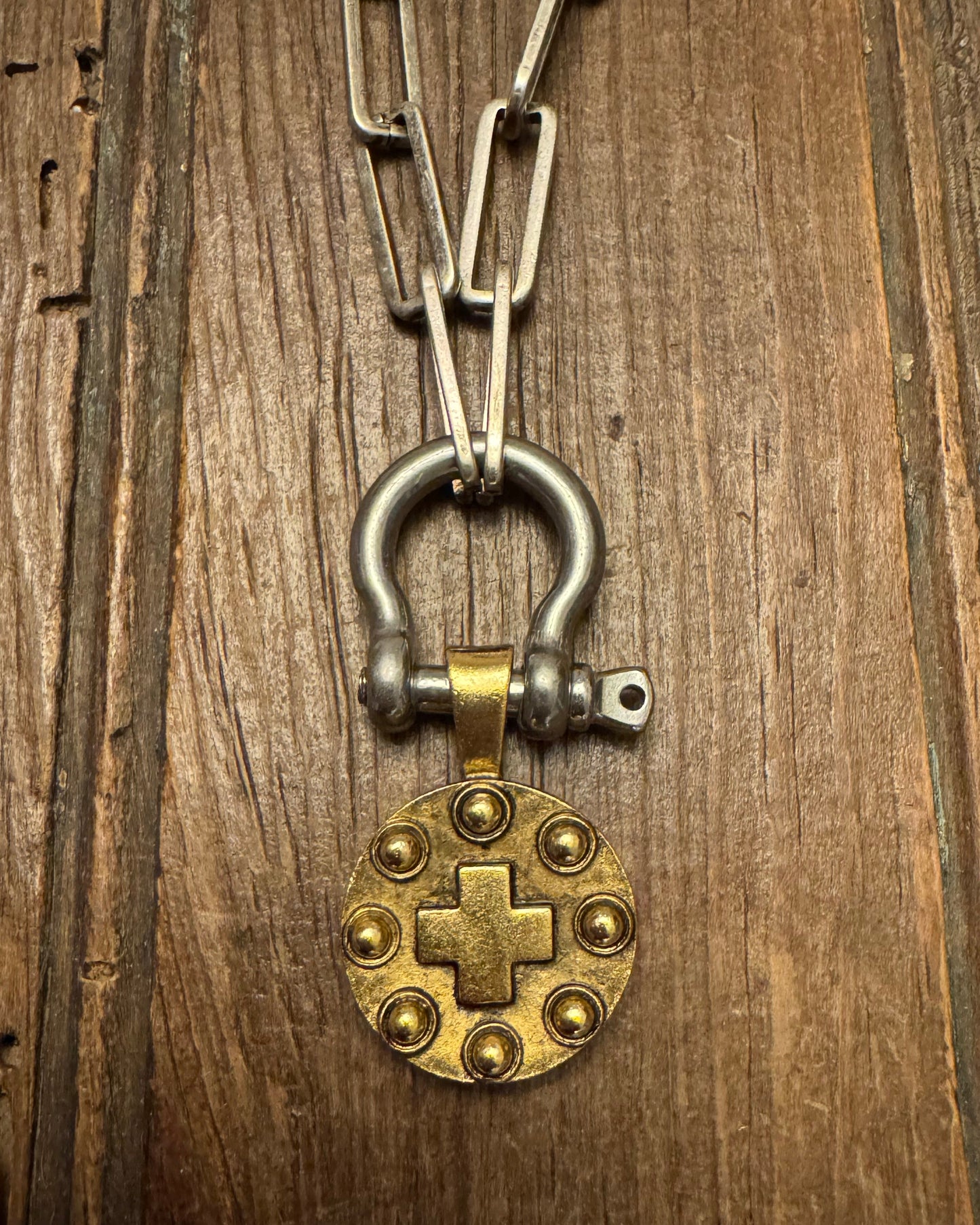 Vintage-style keychain with a brass lock charm on a wooden surface