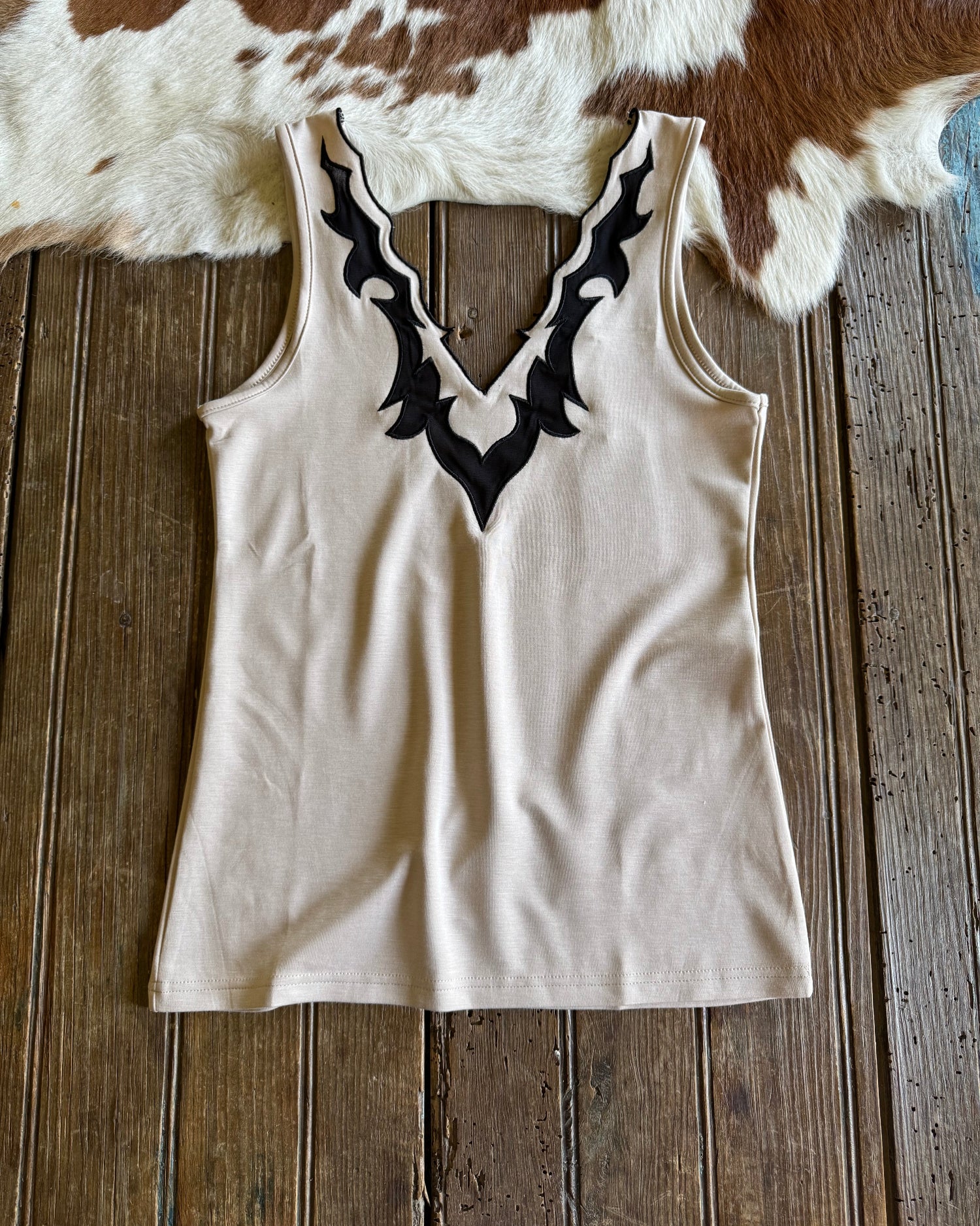 Llano tank top on rustic wood and cowhide background