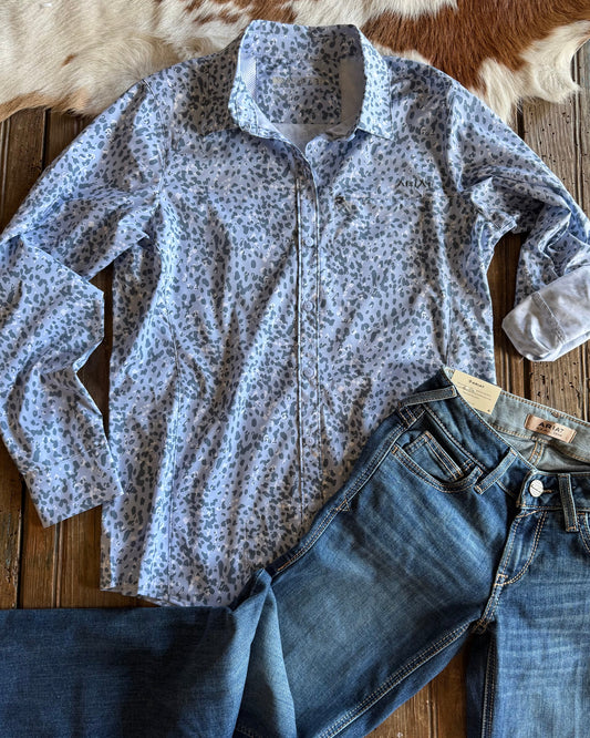 blue leopard print button up shirt with jeans on rustic wood background