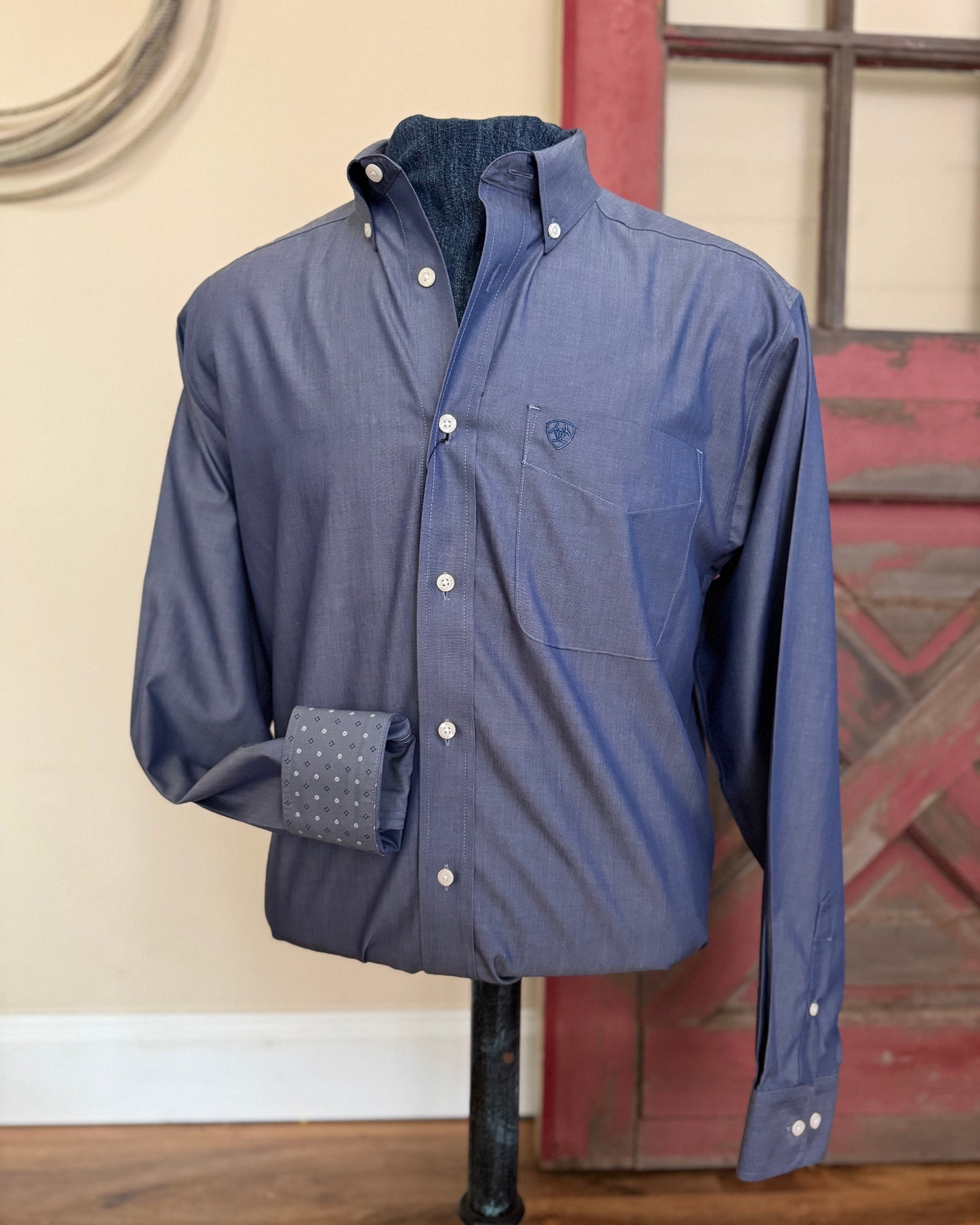 Blue shirt on a mannequin with a rustic background