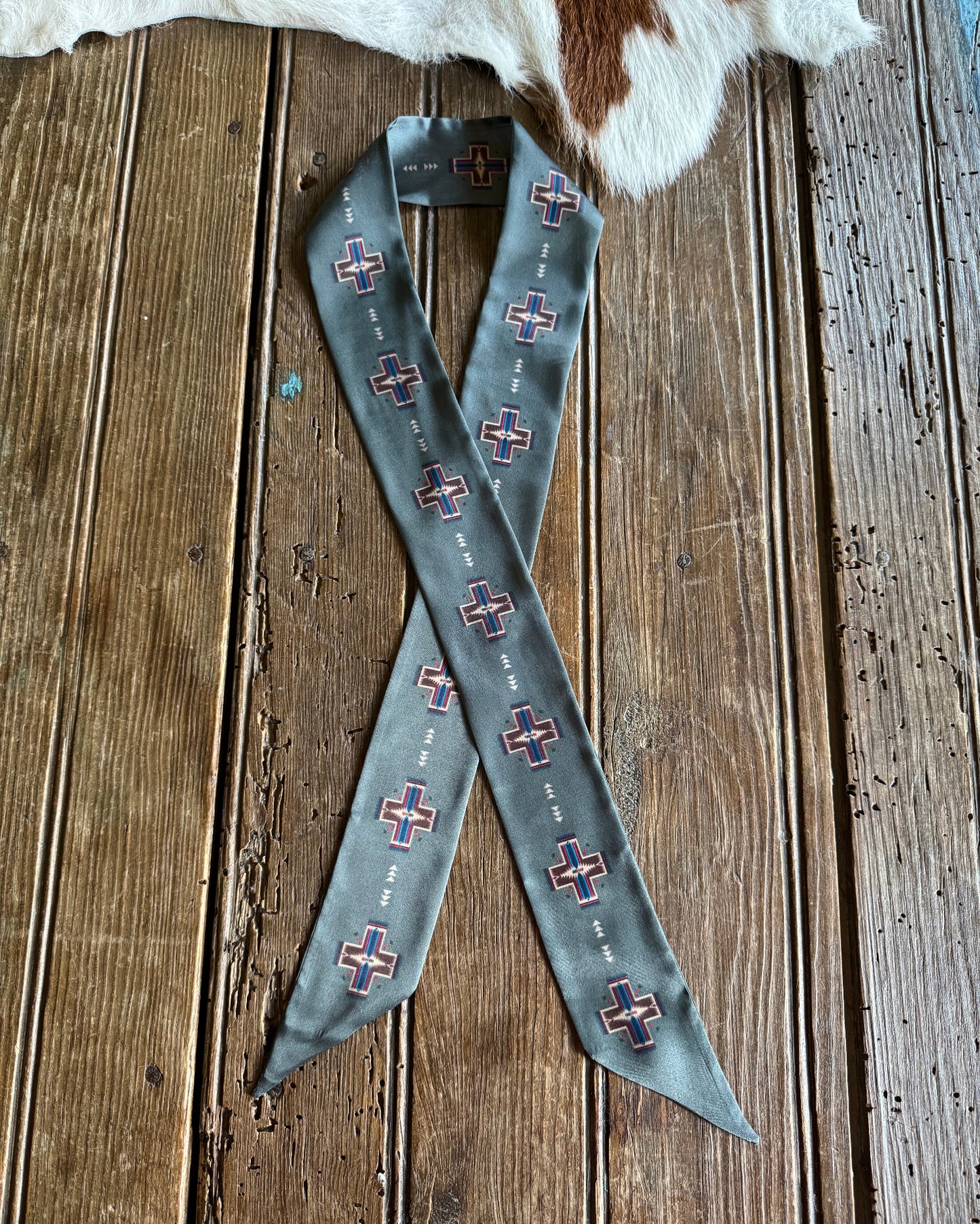 grey scarf with pattern on a wooden surface