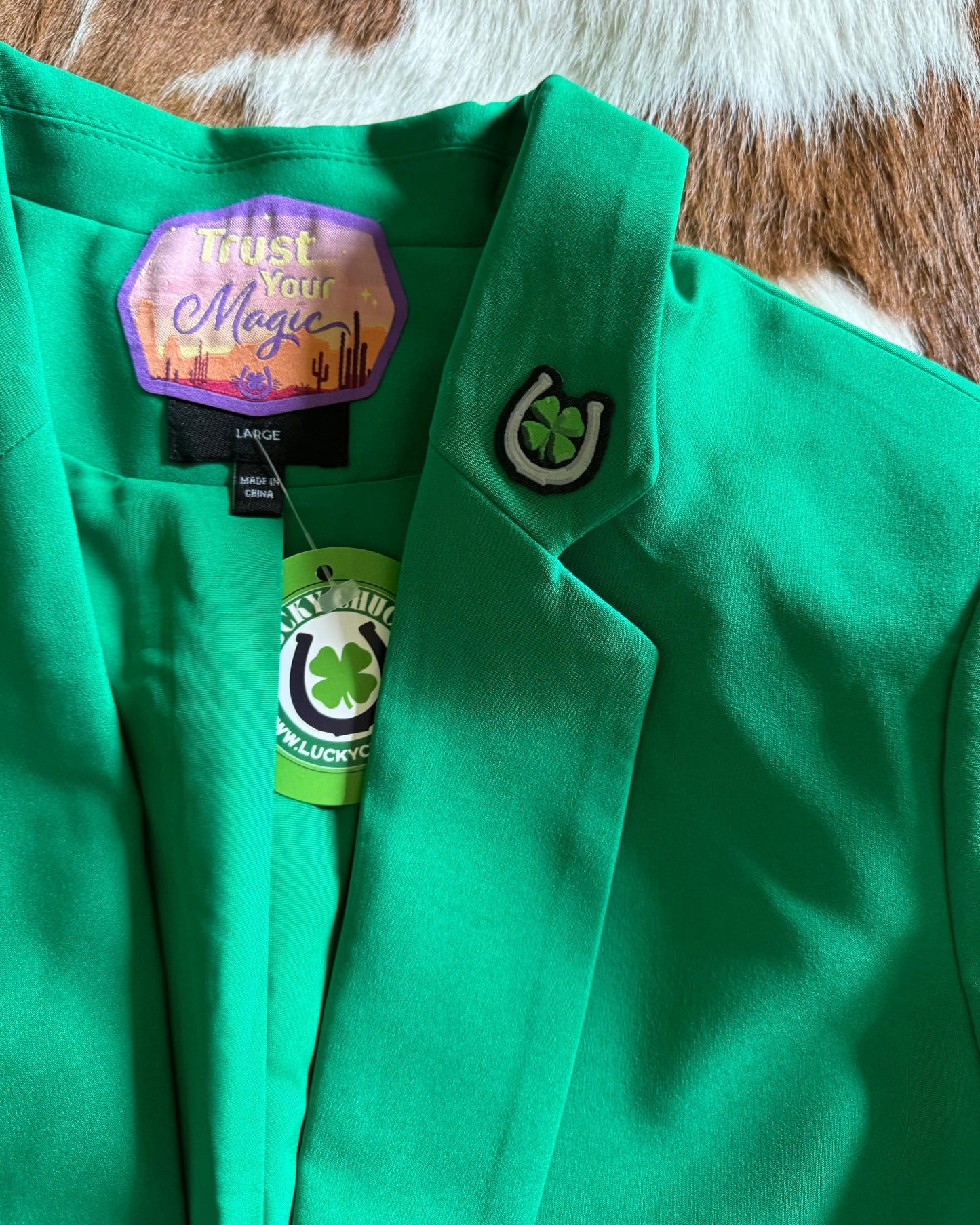 Small clover and horse shoe patch on blazer lapel