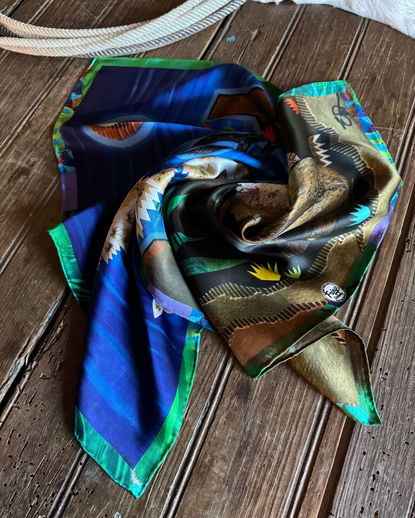Colorful scarf with animal print on a wooden surface
