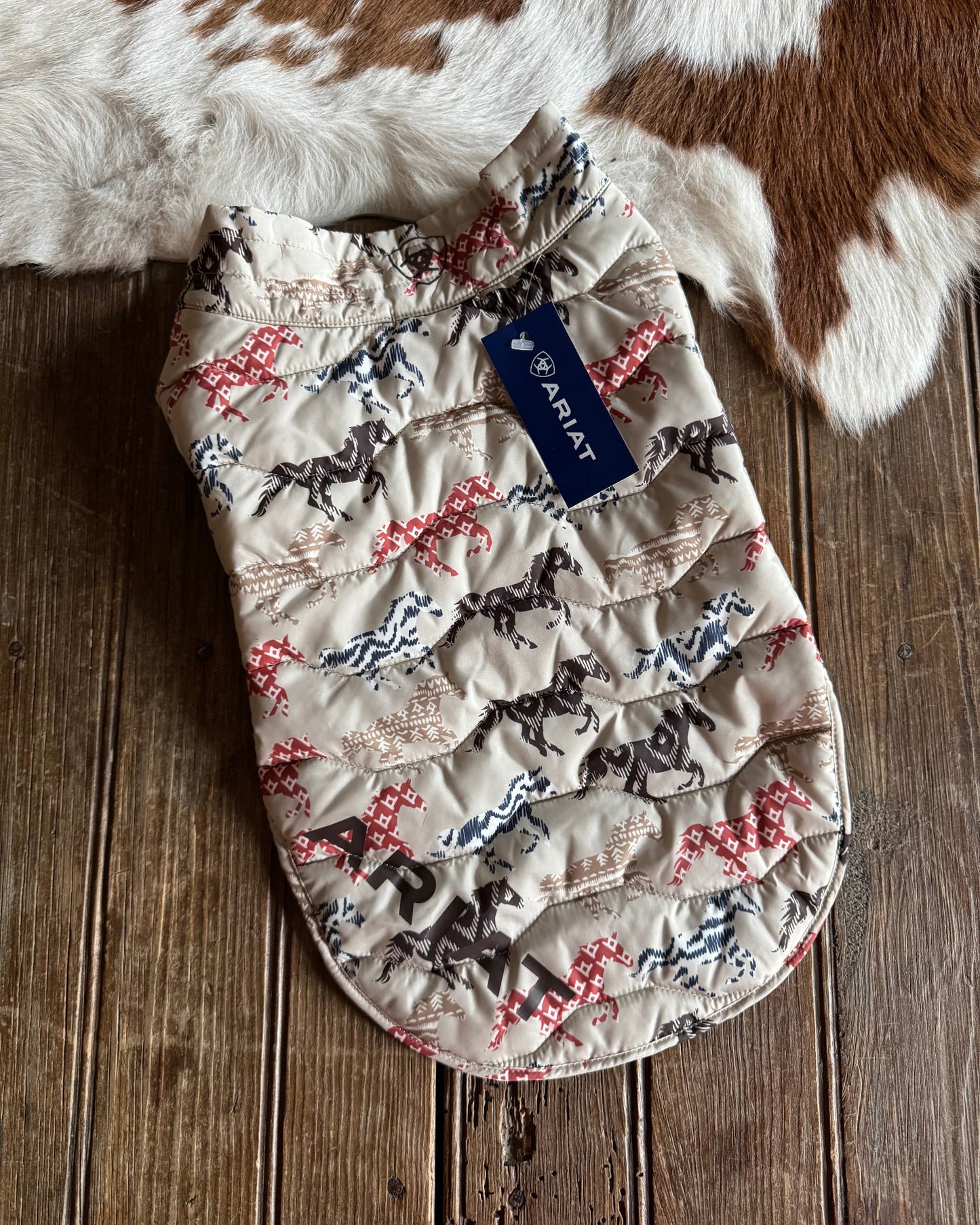 Quilted product with Ariat logo on a wooden surface
