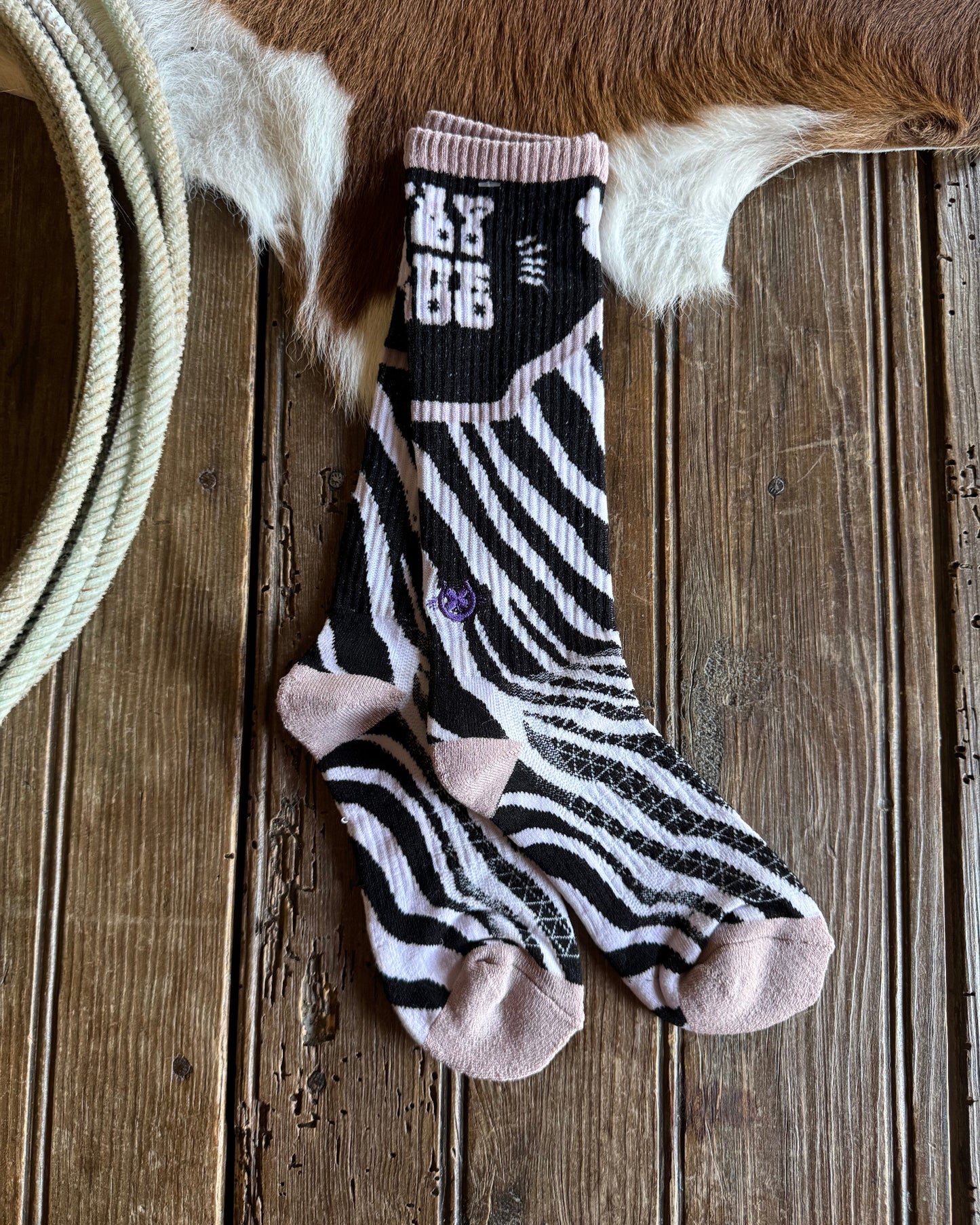 Zebra-patterned sock with a wooden background