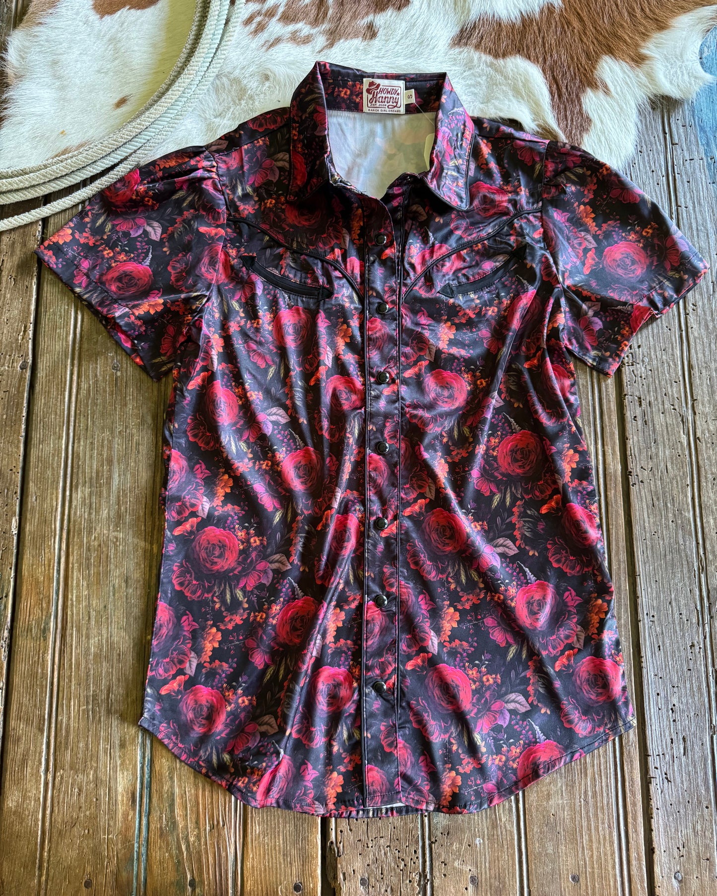 Red and black patterned shirt on a wooden surface