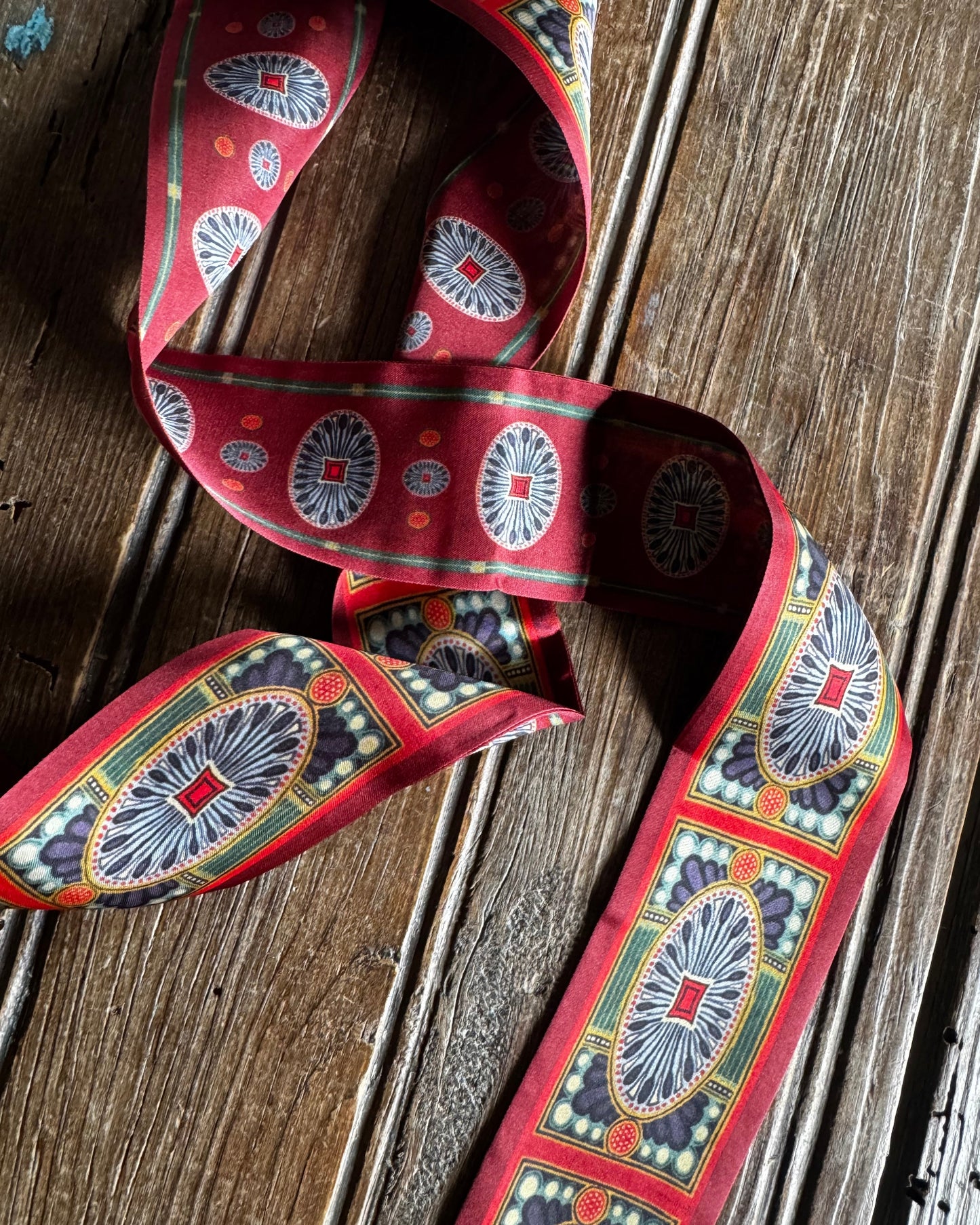 Decorative ribbon with intricate patterns on a wooden surface