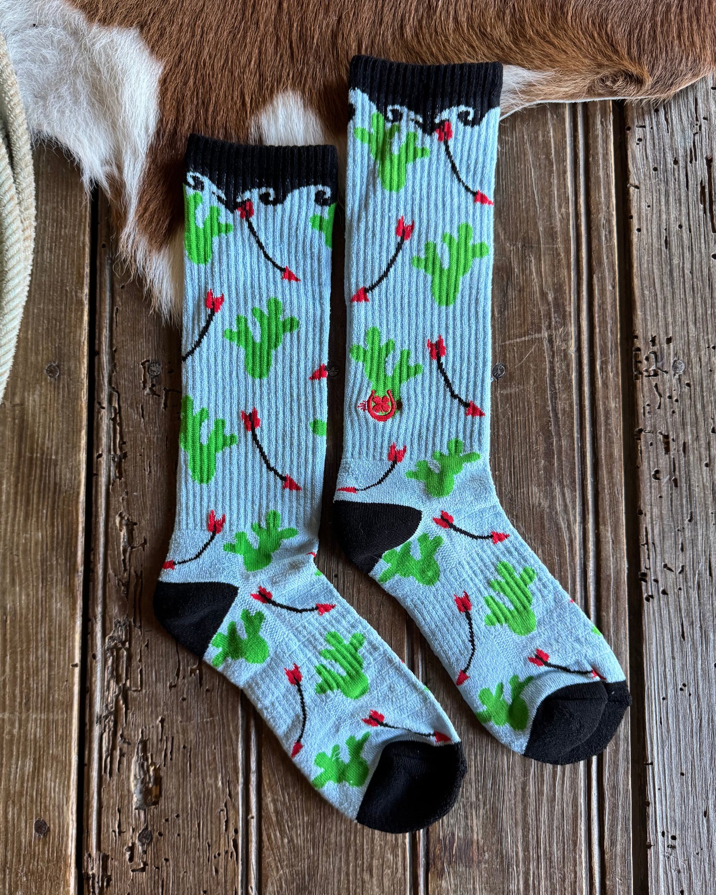Pair of socks with a floral pattern on a wooden surface
