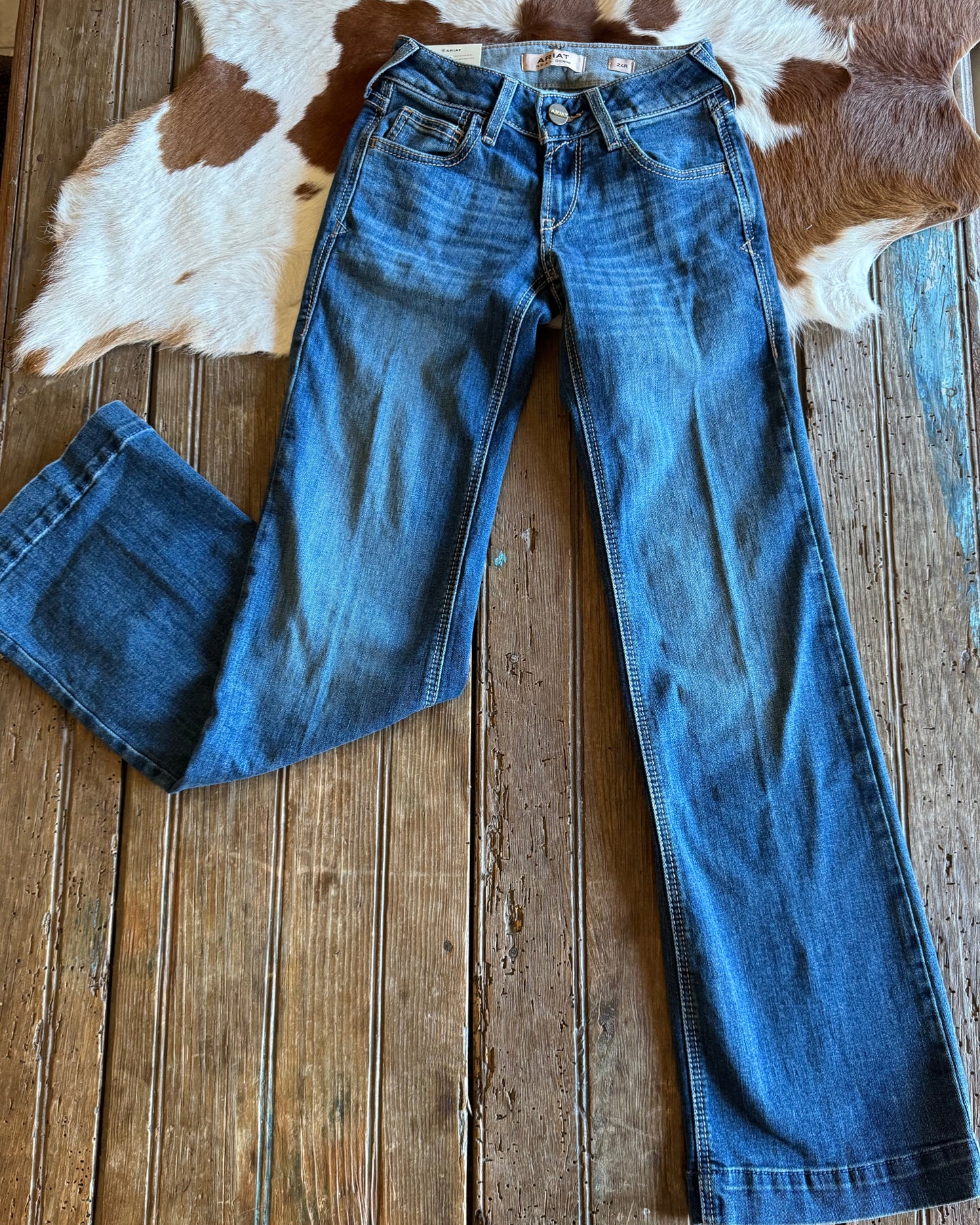 Trouser jeans on a rustic wood background