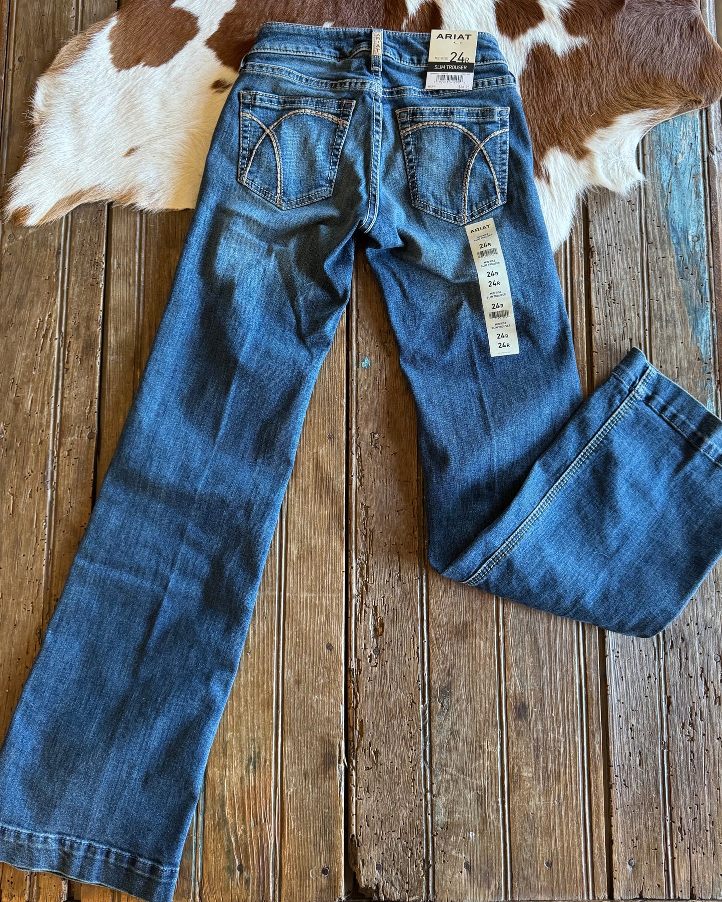 Back of trouser jeans on rustic wood background