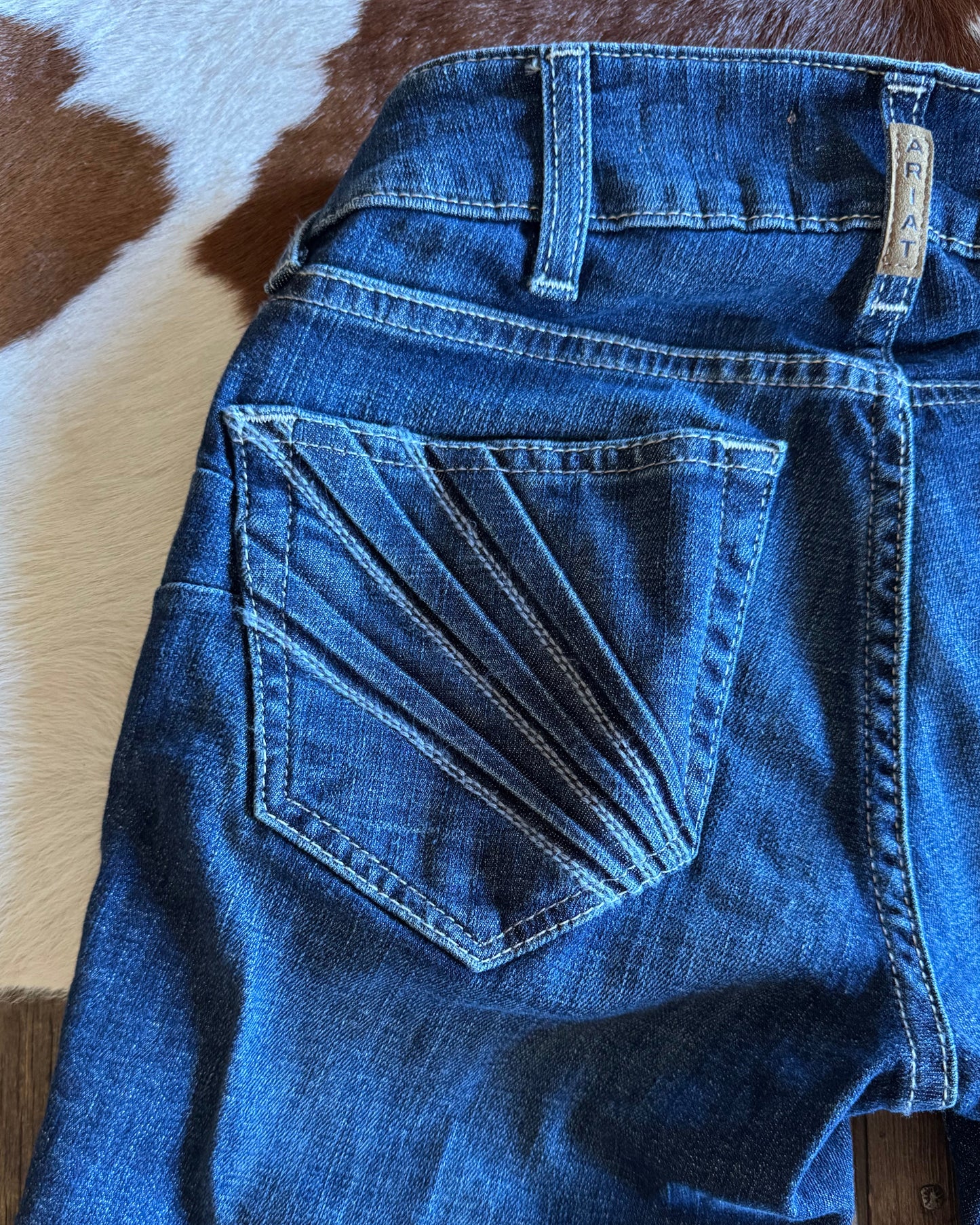 Back pocket of jeans on cowhide background