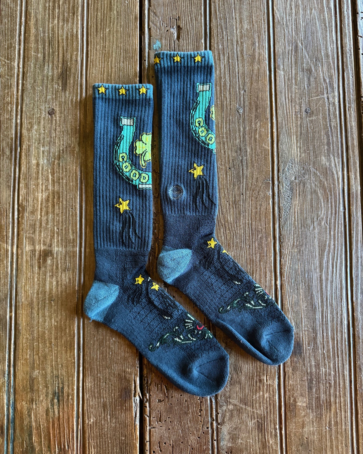 Fringe Lucky Horseshoe Performance Socks in blue on rustic wood background