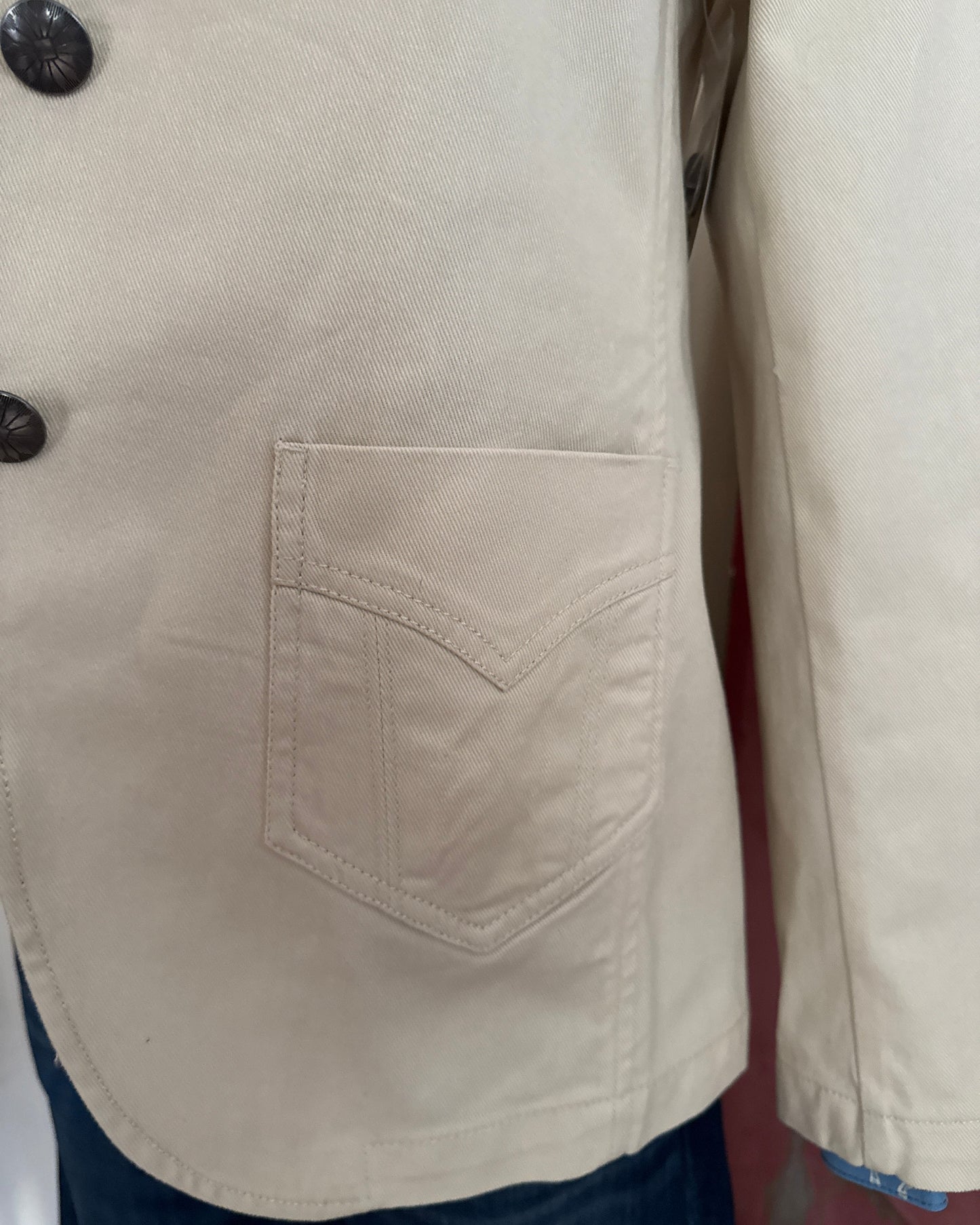 Close-up of beige jacket with button details