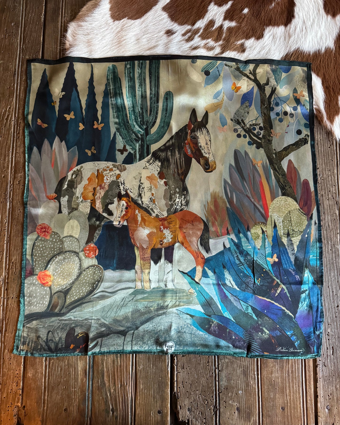 Colorful scarf with animal design on a wooden surface