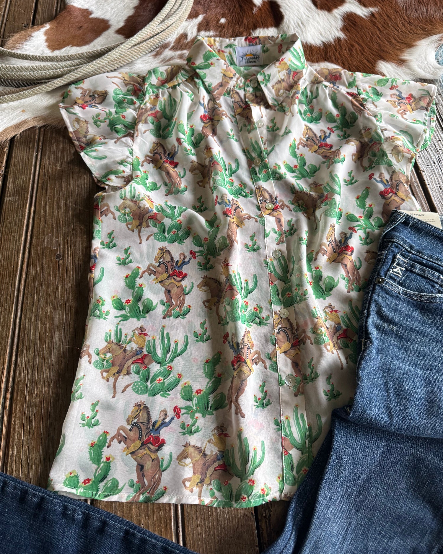 Floral-patterned shirt with blue jeans on a wooden surface