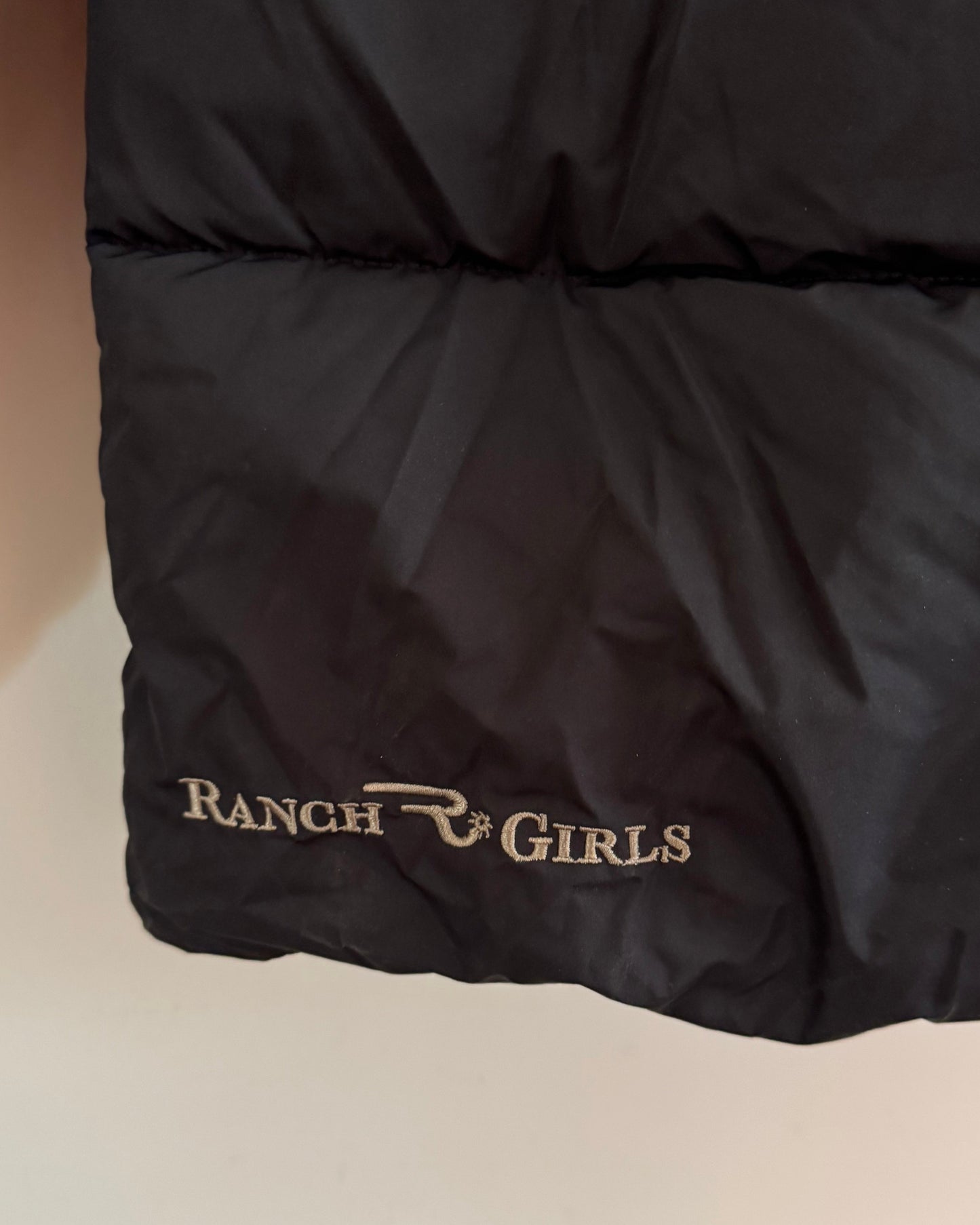 Black jacket with 'Ranch Girls' branding on a light background