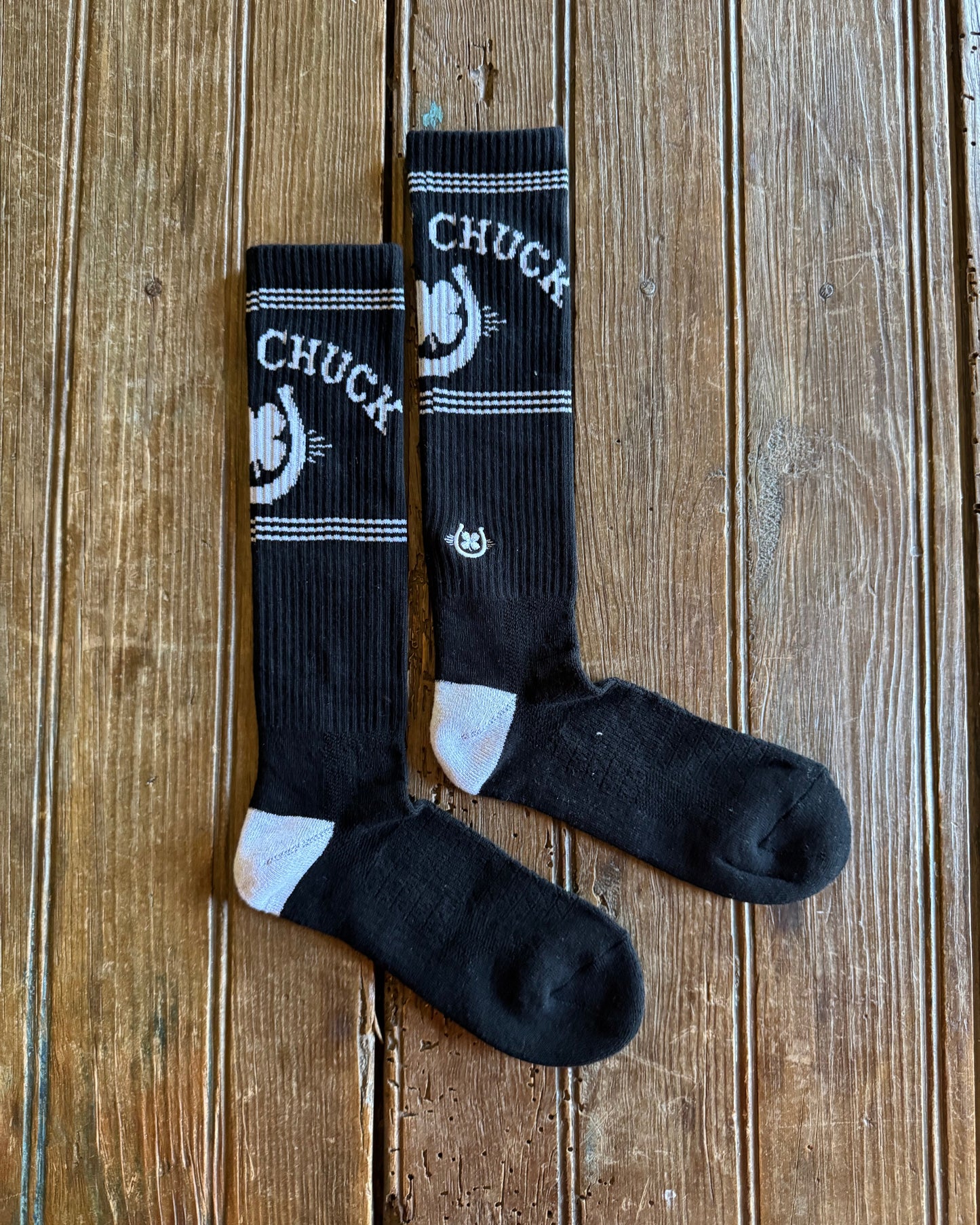 Retro Lucky Chuck Performance Socks (Black/White) on rustic wood background