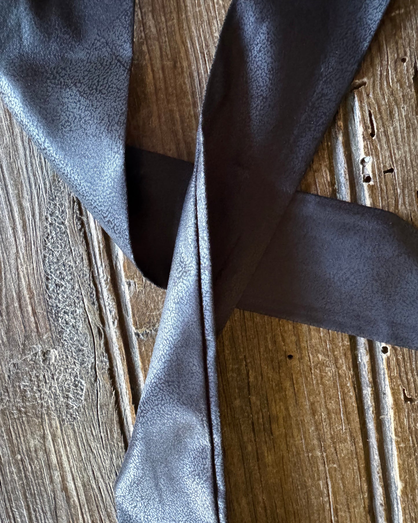 Dark gray fabric on a wooden surface