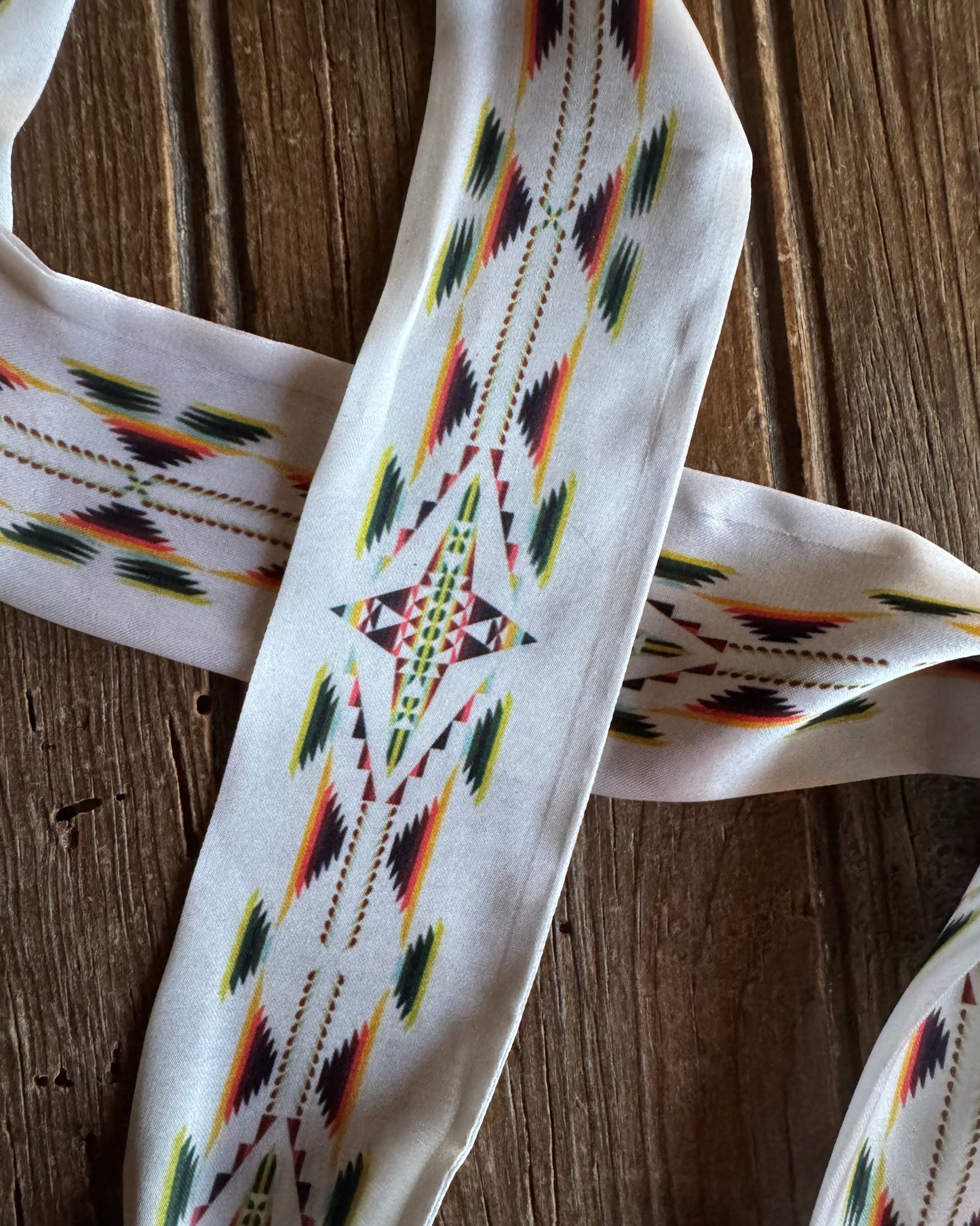 ribbon scarf with geometric pattern on a wooden surface