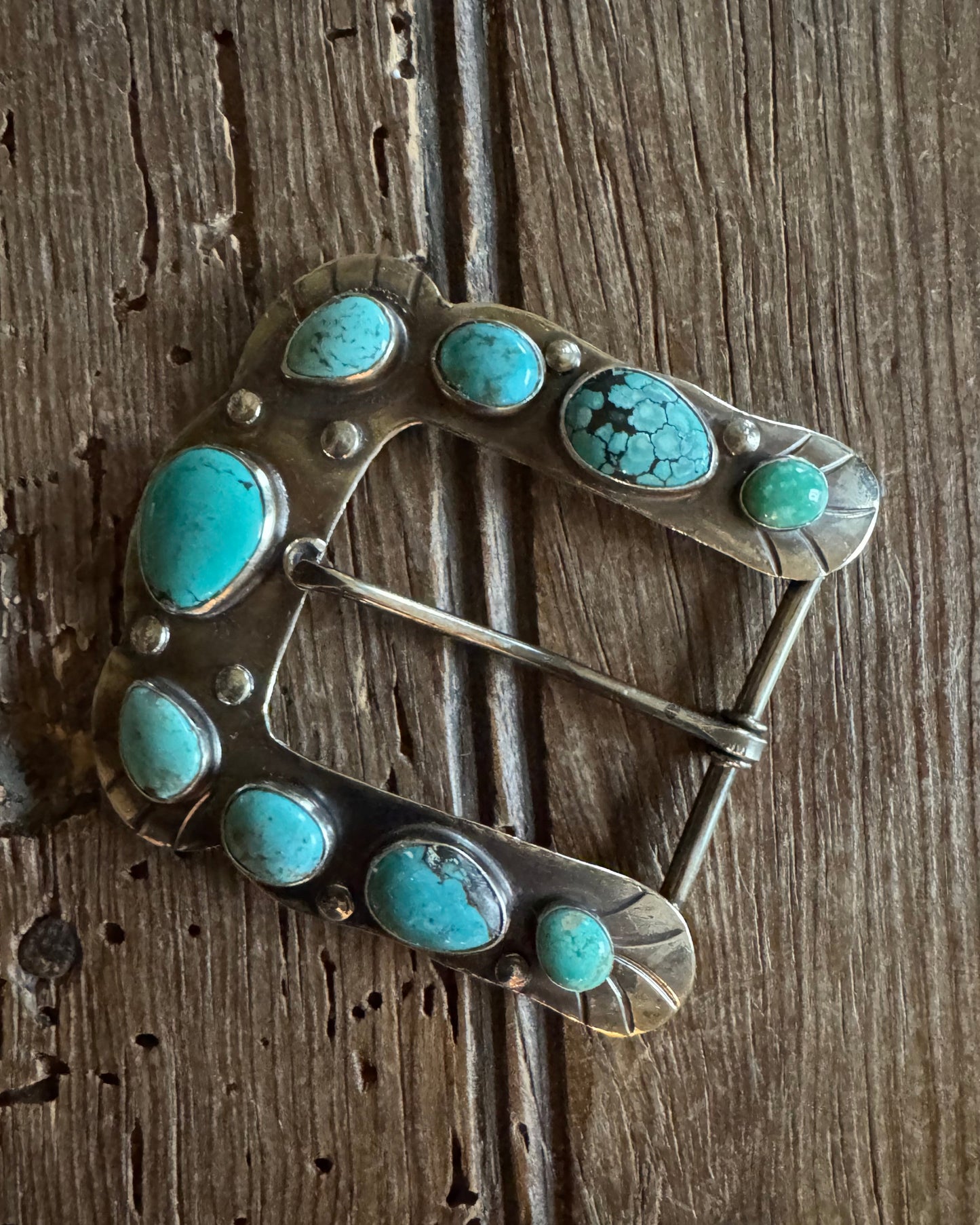 Horse shoe buckle 2 with turquoise on rustic wood background