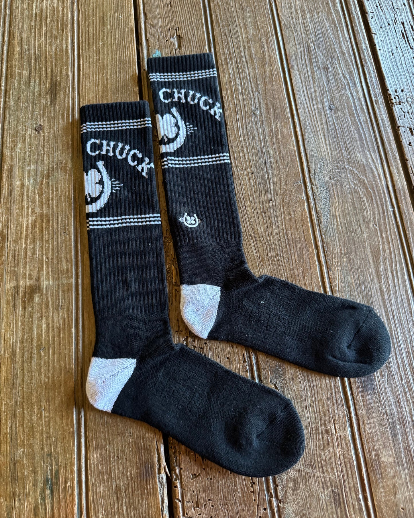 Retro Lucky Chuck Performance Socks on rustic wood background