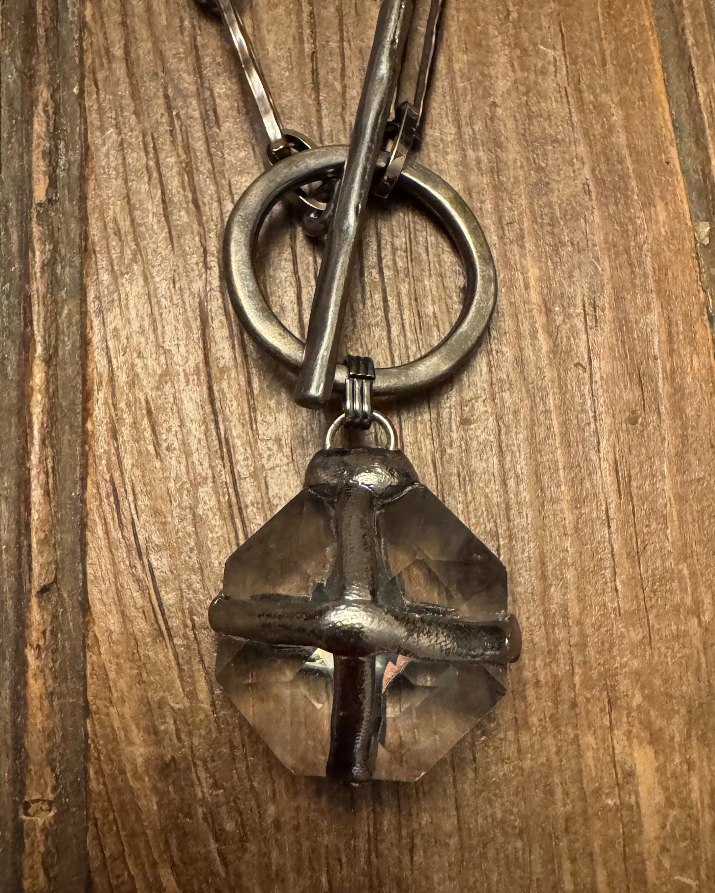 Metal necklace on a wooden surface