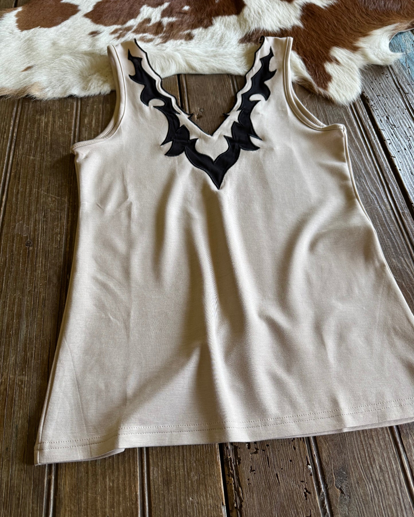 Close up of llano tank top on rustic wood and cowhide background