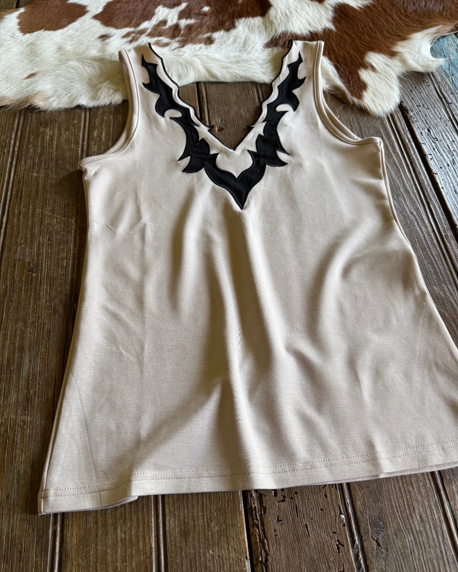 Close up of llano tank top on rustic wood and cowhide background