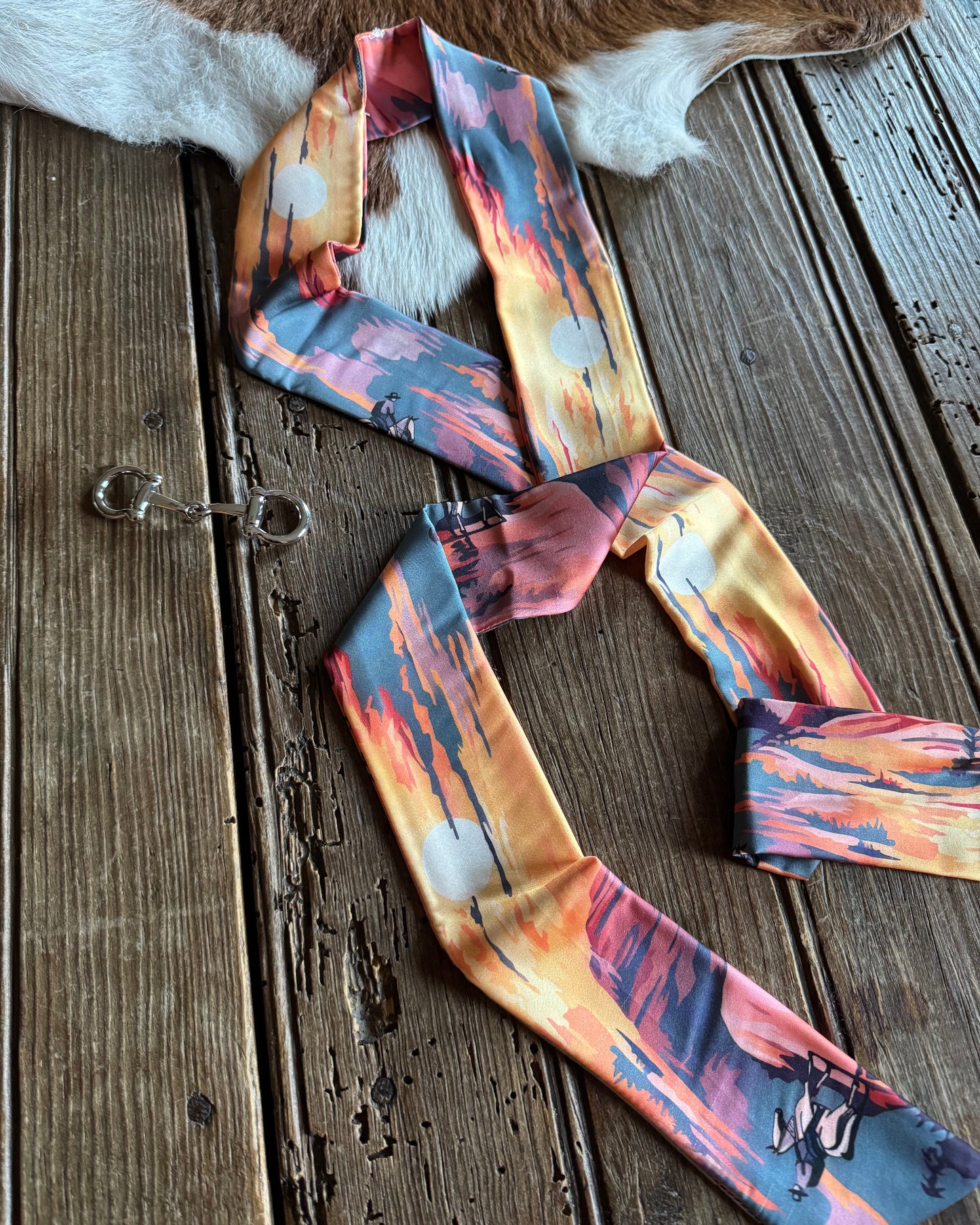 Colorful ribbon scarf on a wooden surface