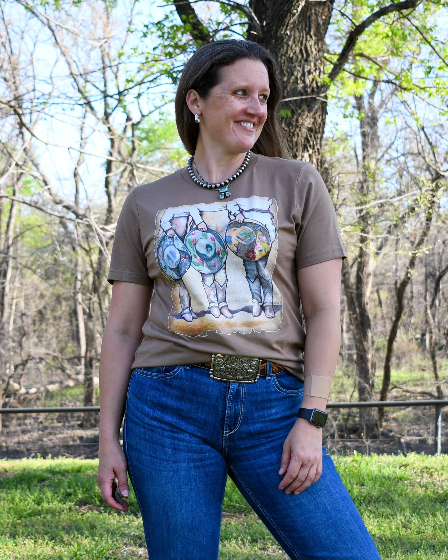 Cowgirls & Cowboy Hats Tee on model with wooded background