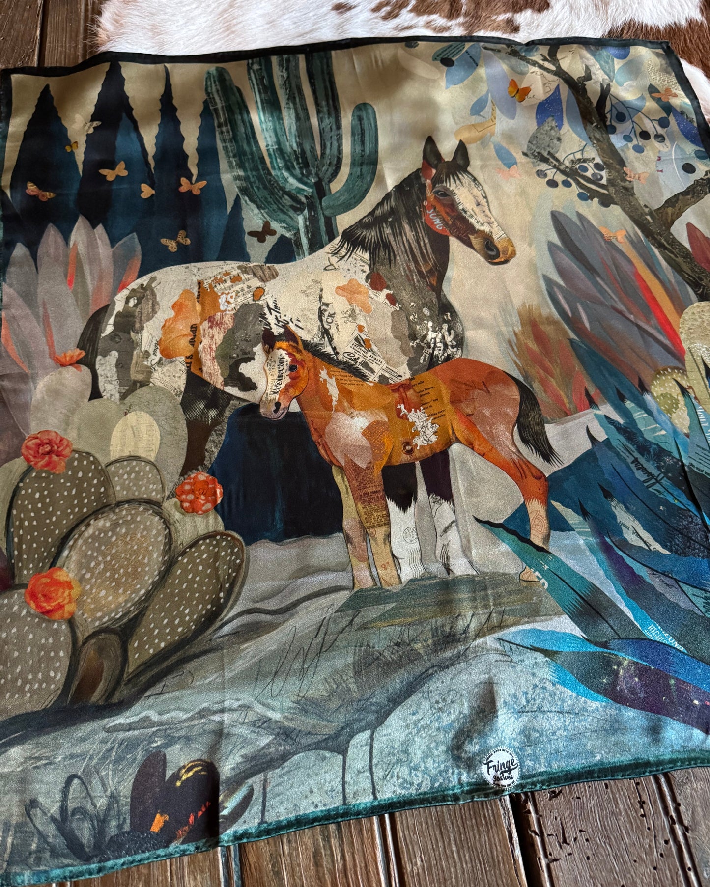 Decorative scarf with nature-themed design on a wooden surface