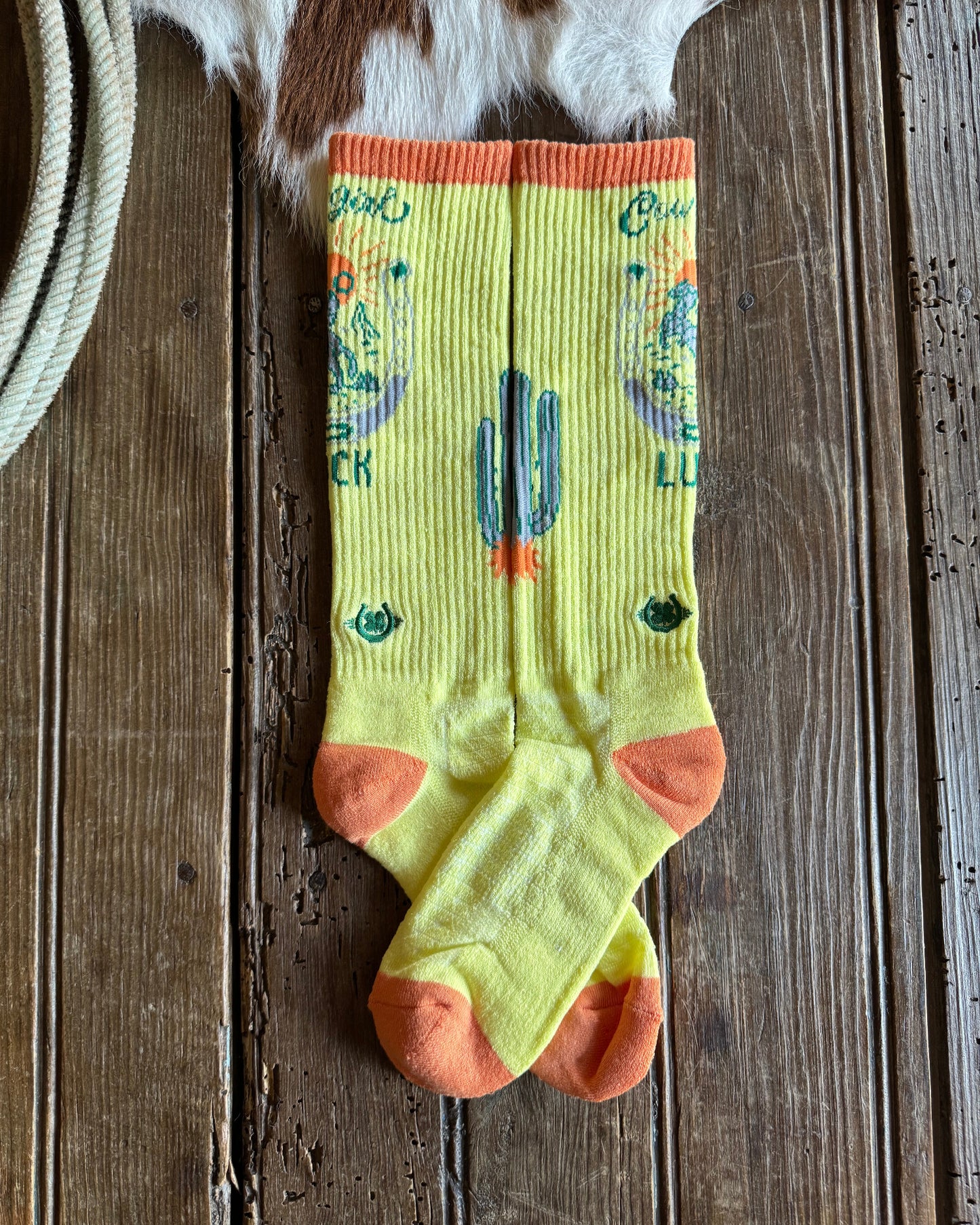 Colorful sock with text and designs on a wooden surface
