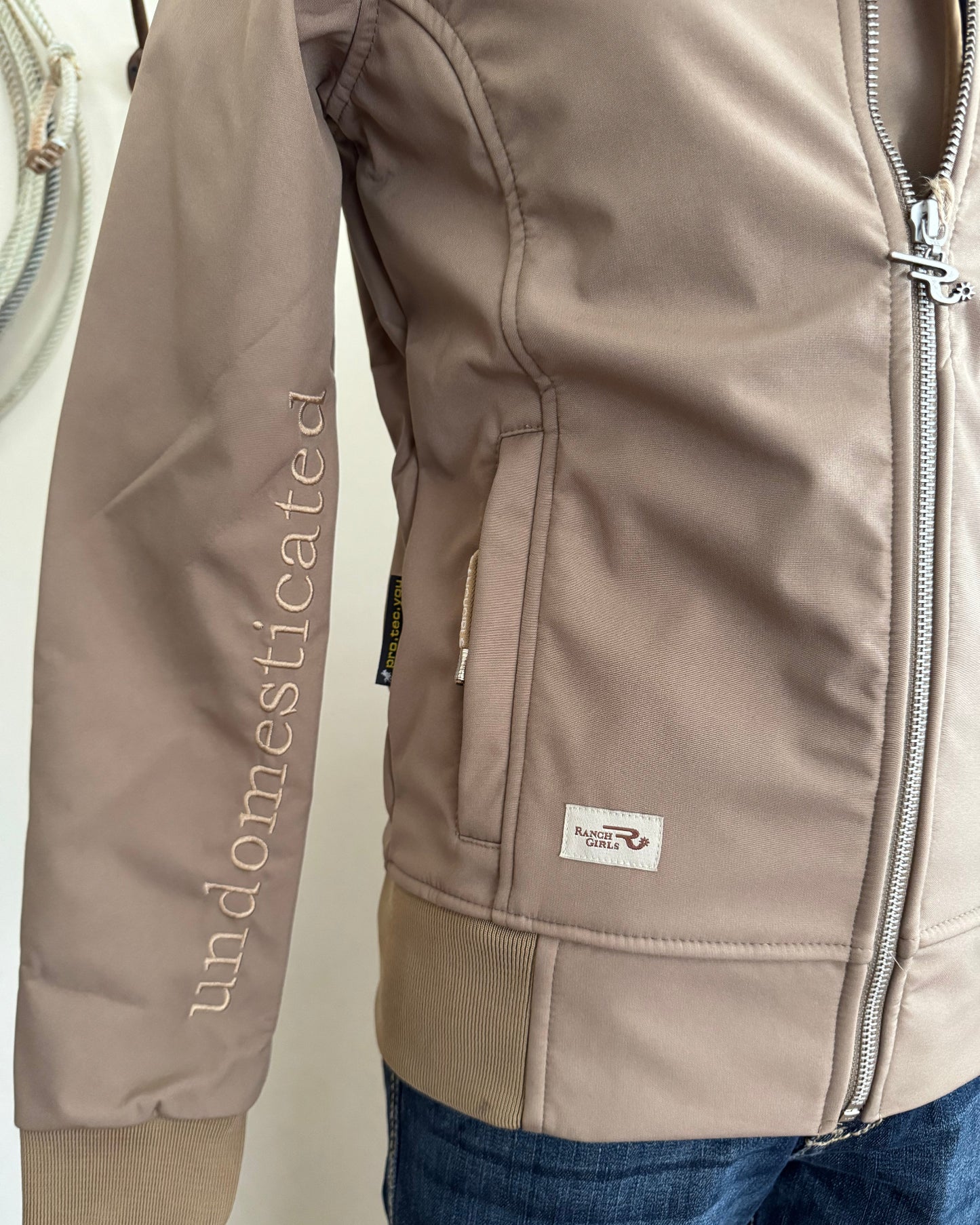 Brown jacket with a brand logo on a white surface