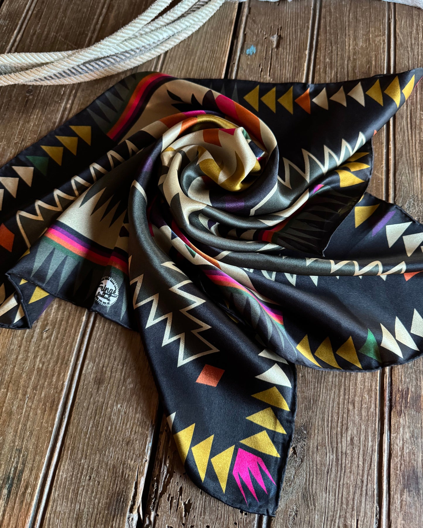 Colorful patterned scarf on a wooden surface