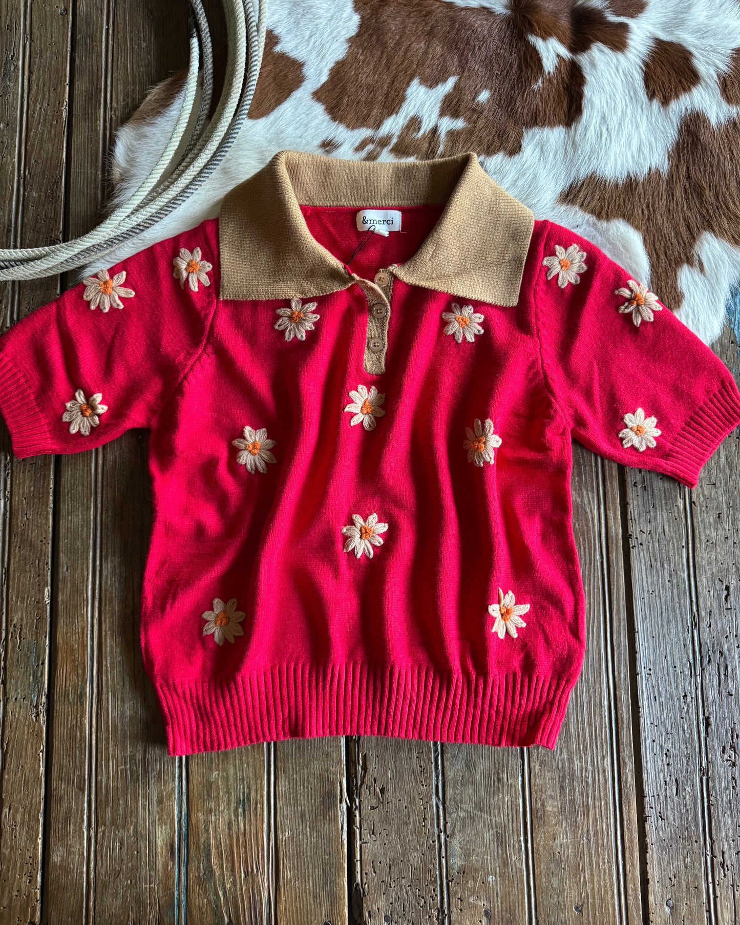 Red outfit with floral patterns on a wooden surface