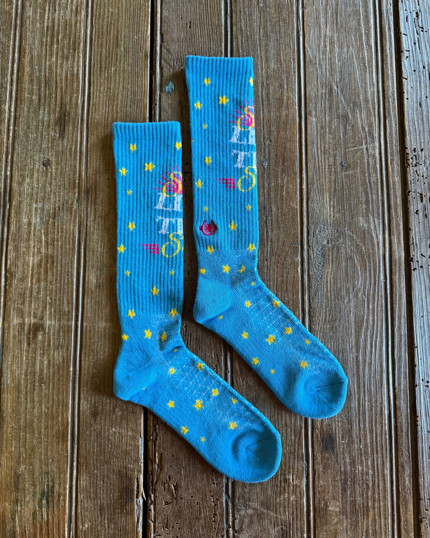 Shine Like a Star Performance Socks in turquoise on rustic wood background