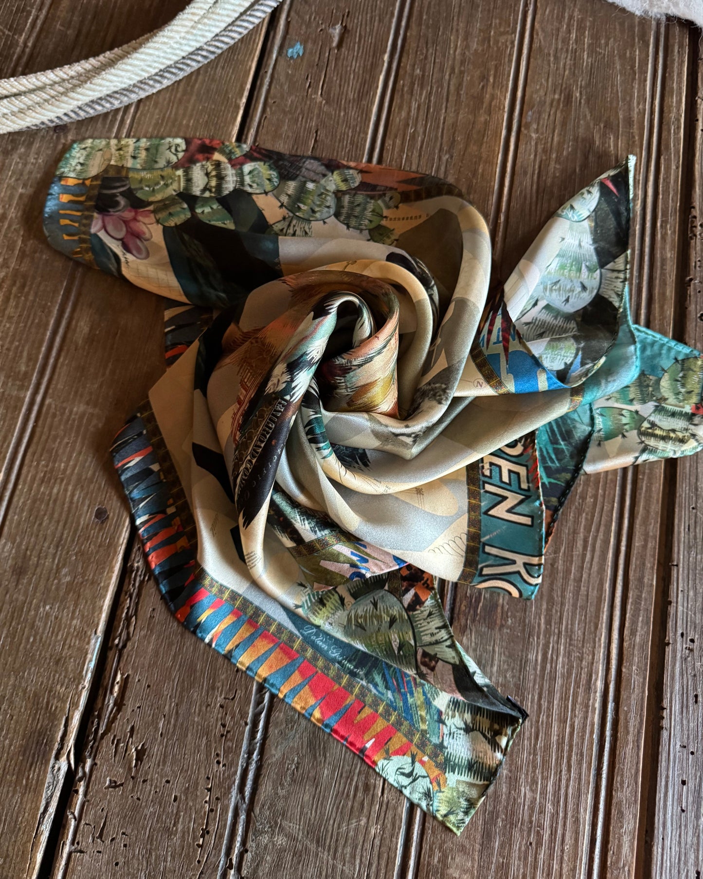 Colorful scarf with patterned design on a wooden surface