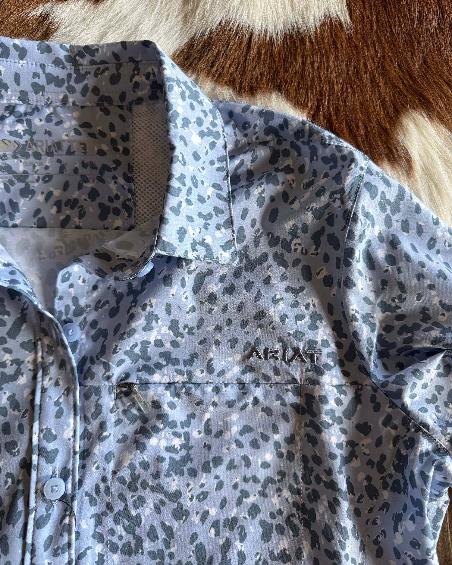 close up of blue leopard shirt on rustic wood background