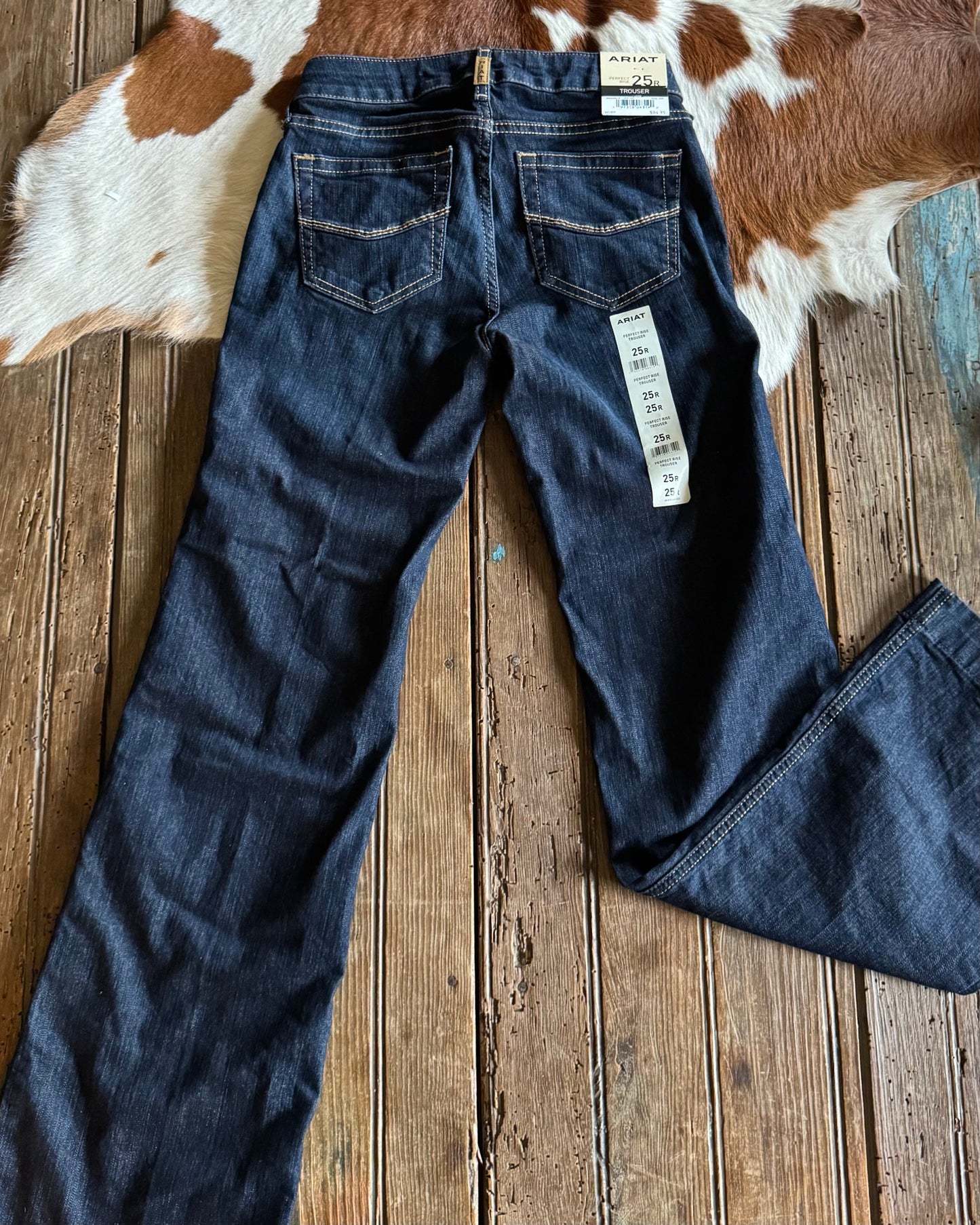back view of Ophelia Perfect Rise Trouser Jeans on rustic wood background