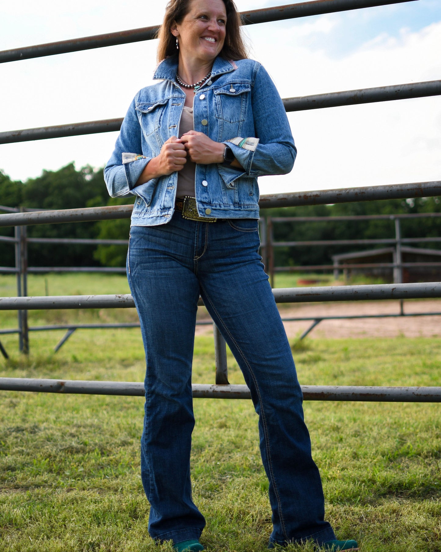 Ella High Rise Slim Trouser Jeans on model standing in front of fence