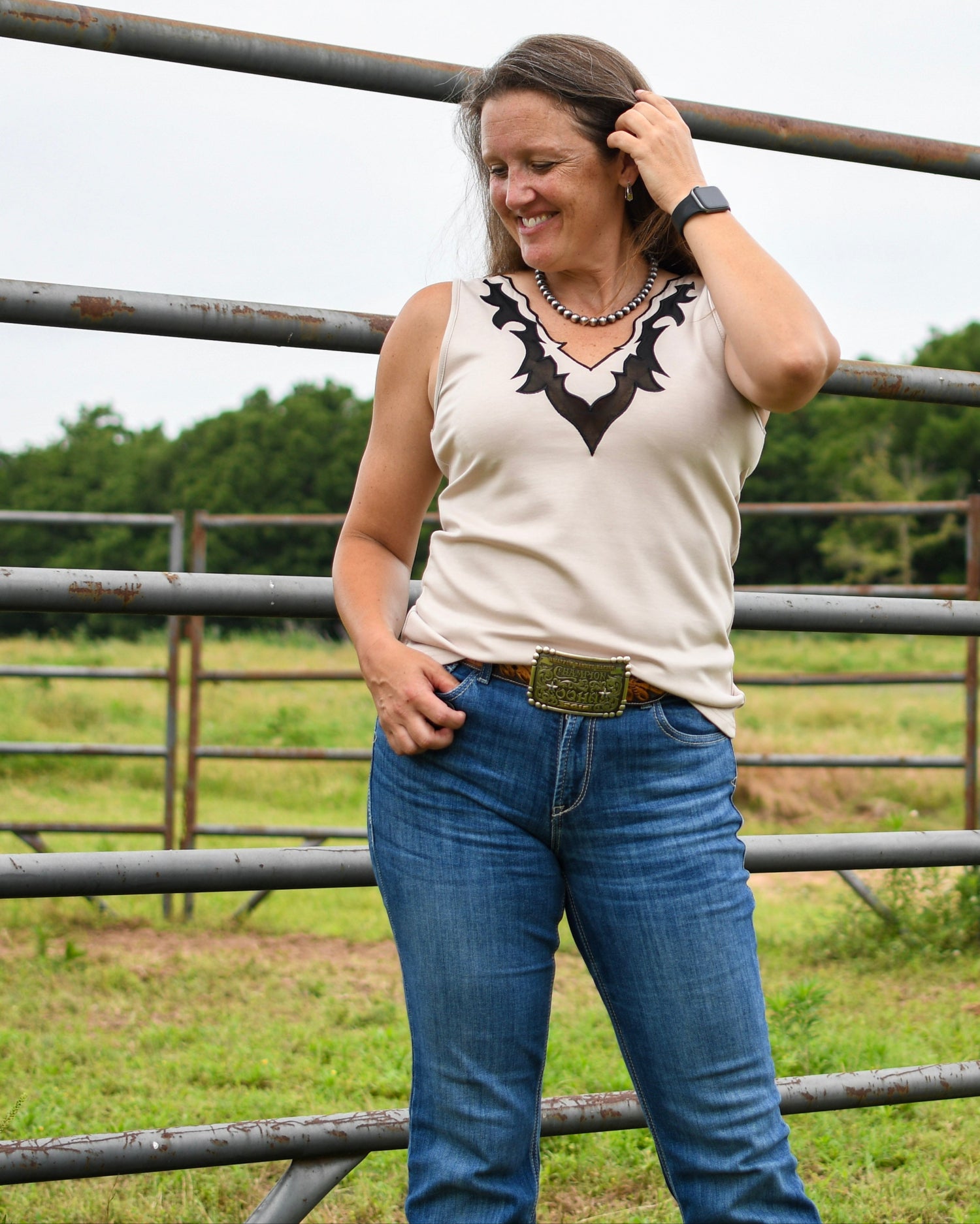 Model wearing llano tank in front of fence