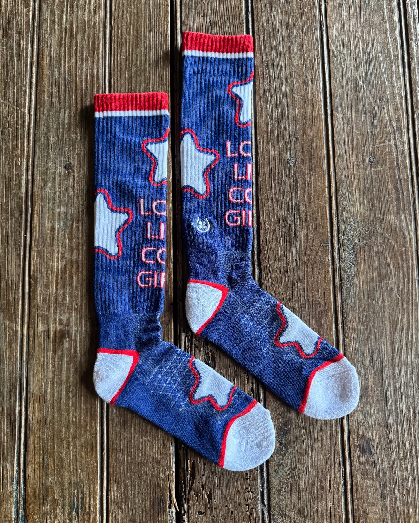 Long Live Cowgirls Performance Socks (Red/Blue) on rustic wood background